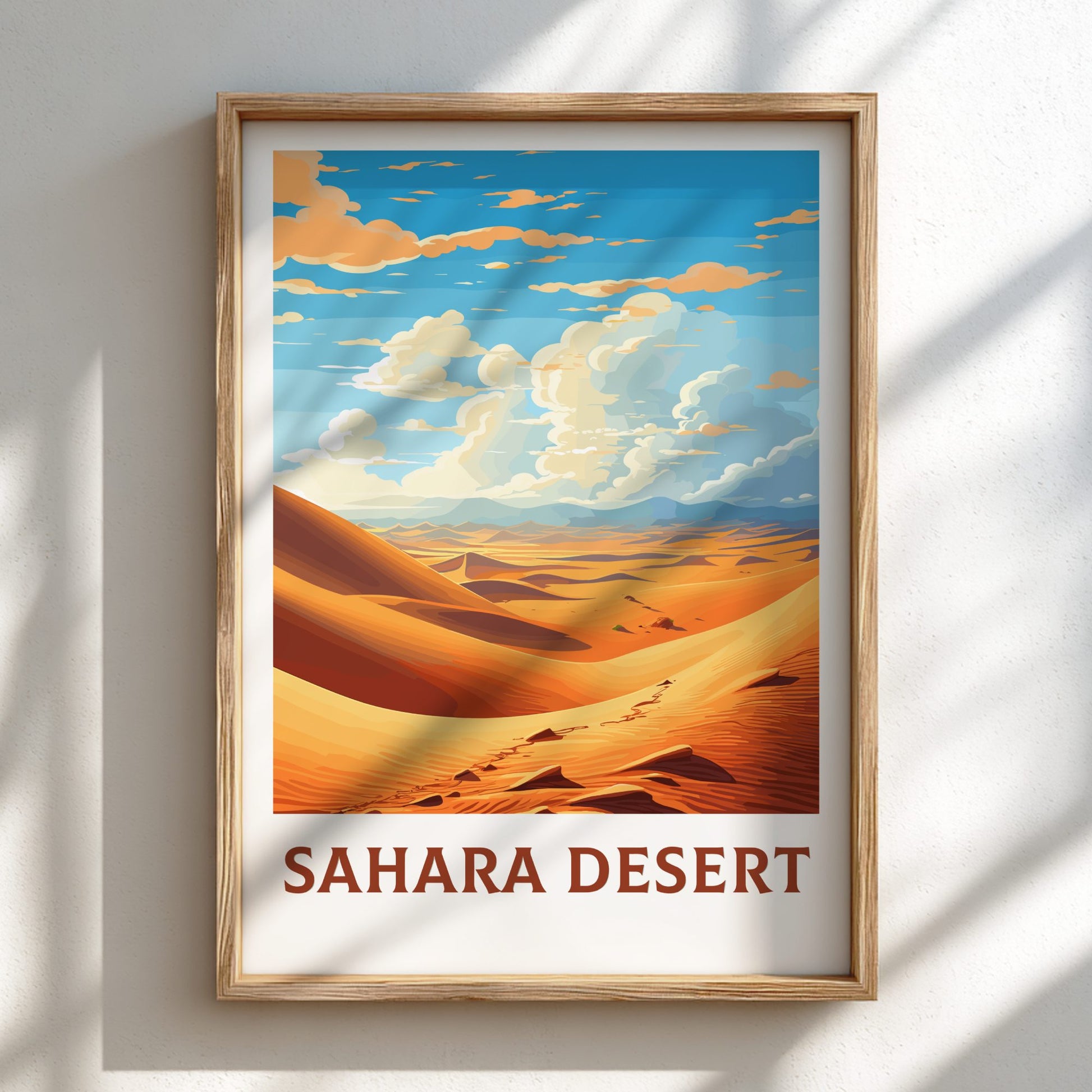 Framed poster of the Sahara Desert with a wooden frame on a light background