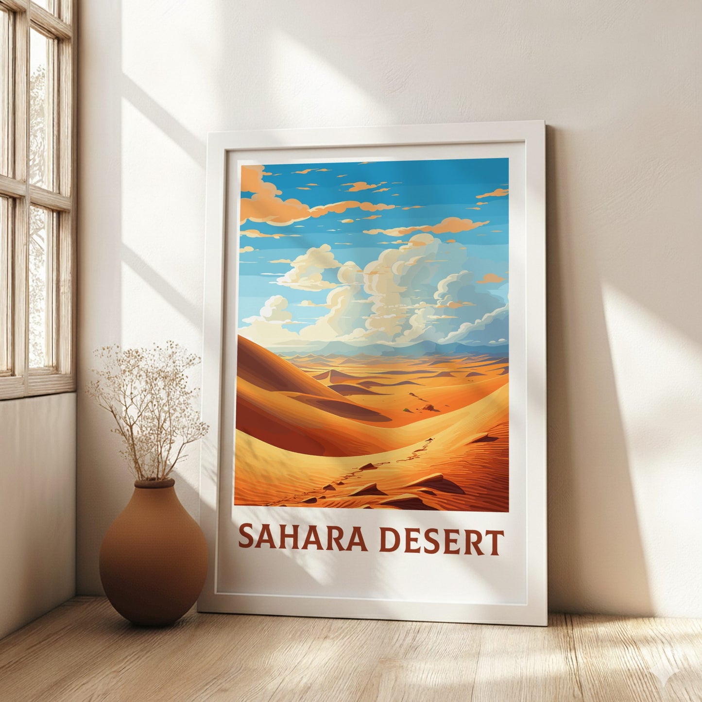 Framed poster of Sahara Desert in a room with a vase and plant