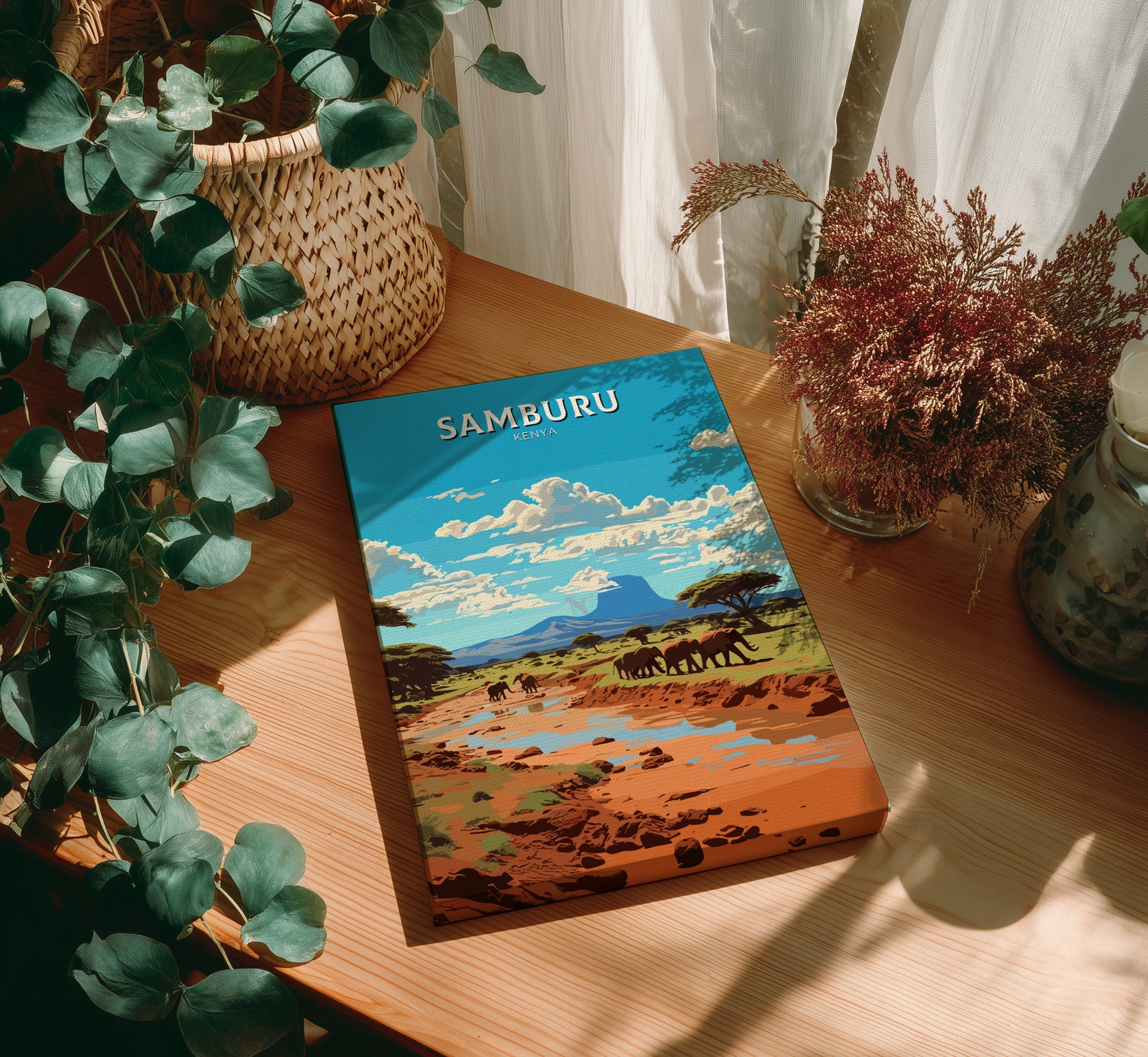 Book titled 'Samburu' on a wooden surface with plants around