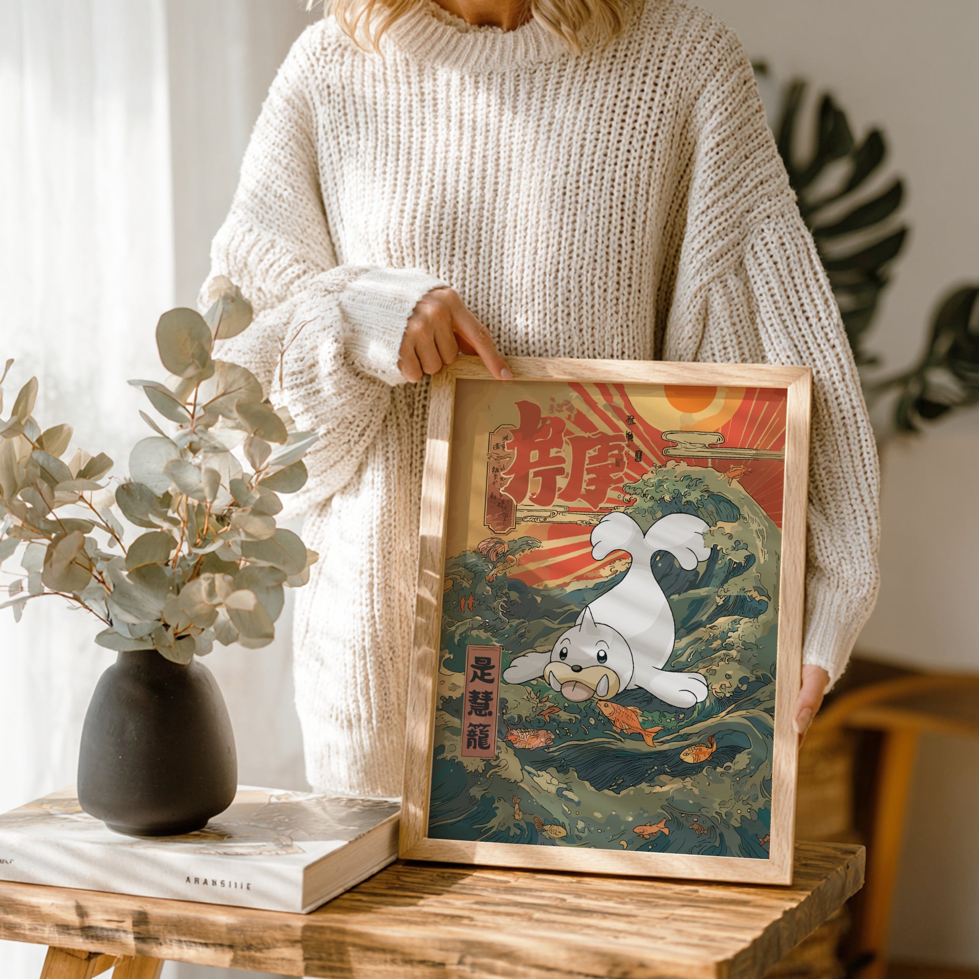 Person holding a framed artwork of Seel Pokemon in a natural setting