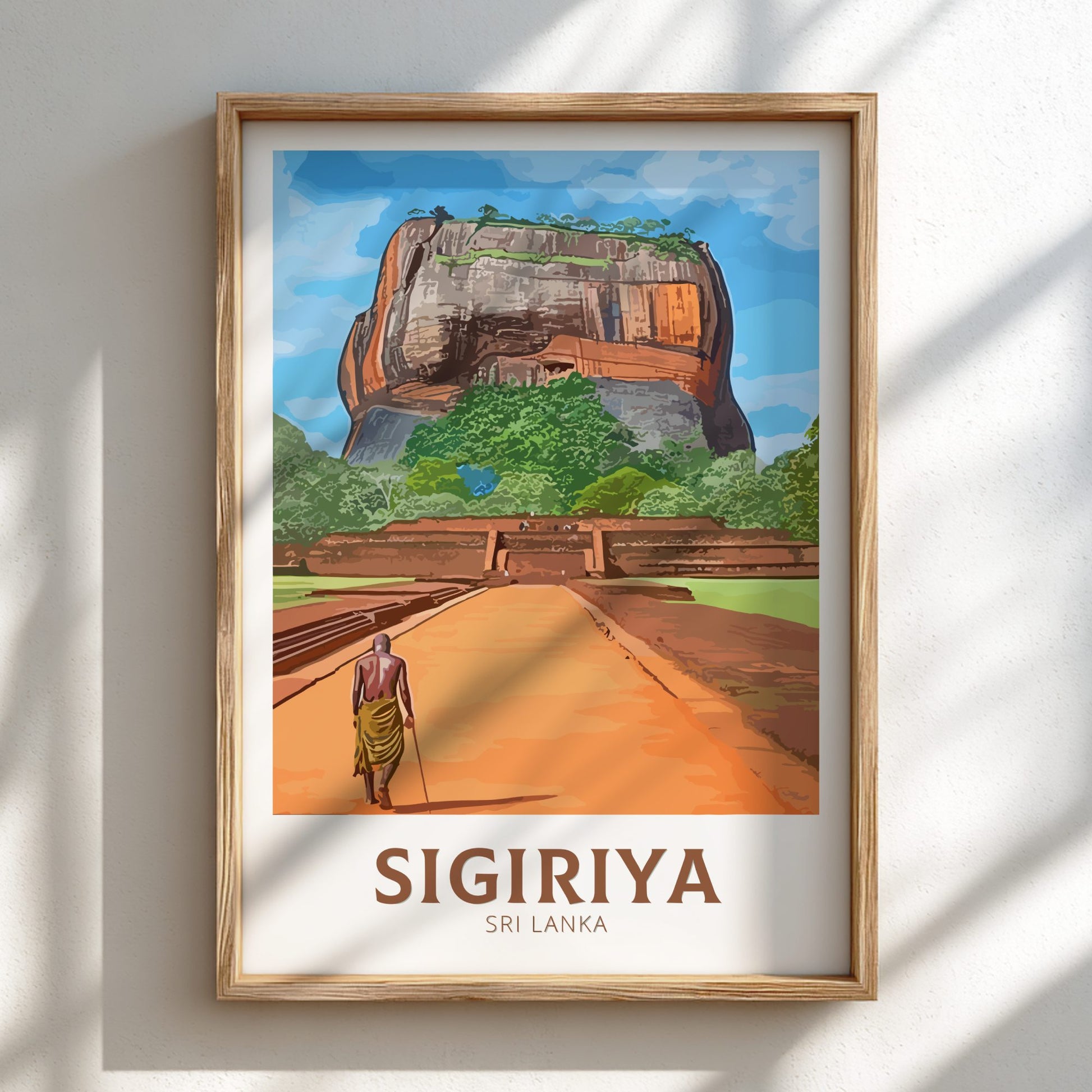 Framed artwork of Sigiriya, Sri Lanka with a person walking towards it.