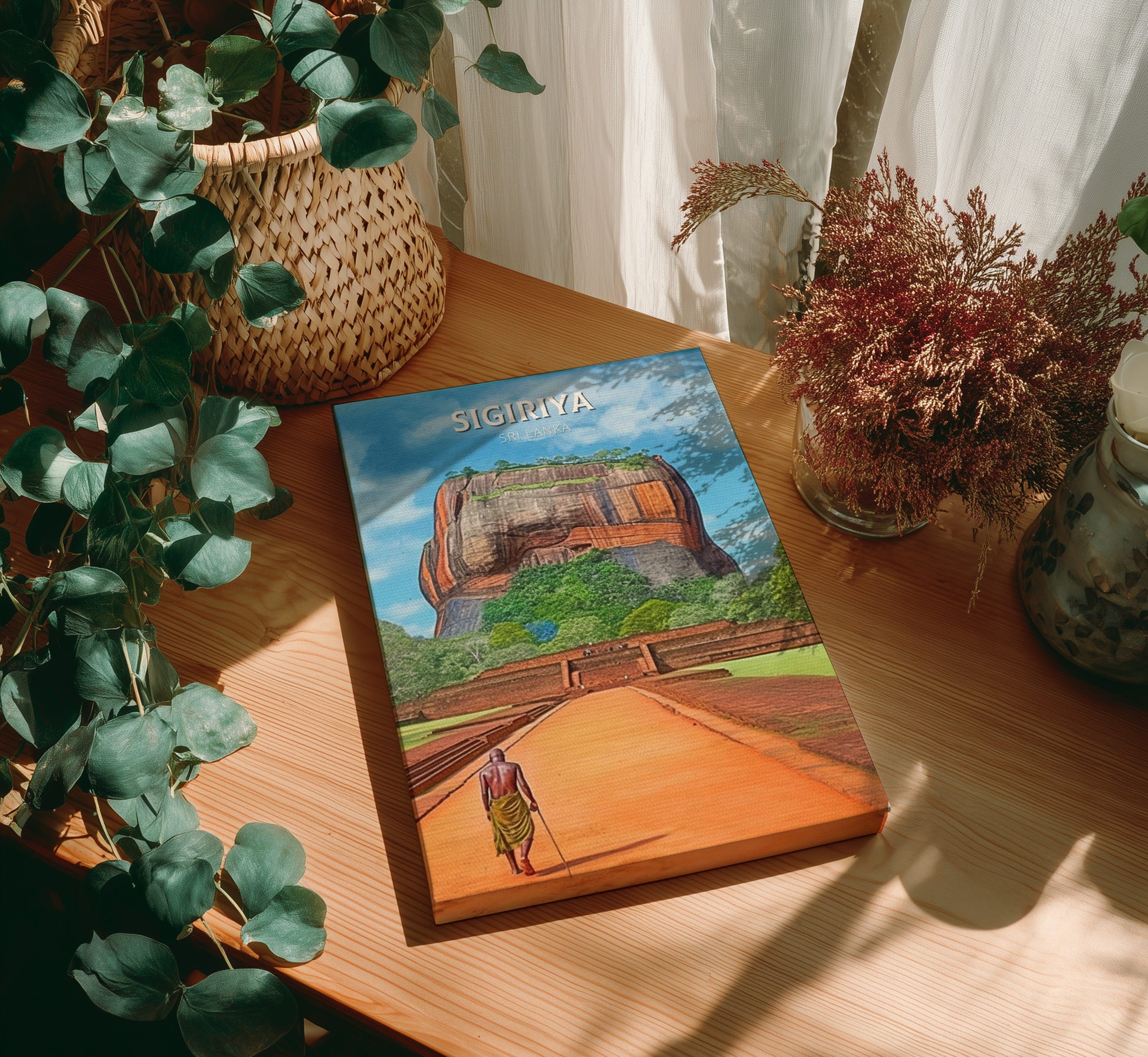 Book titled 'Sigiriya' on a wooden surface with plants around