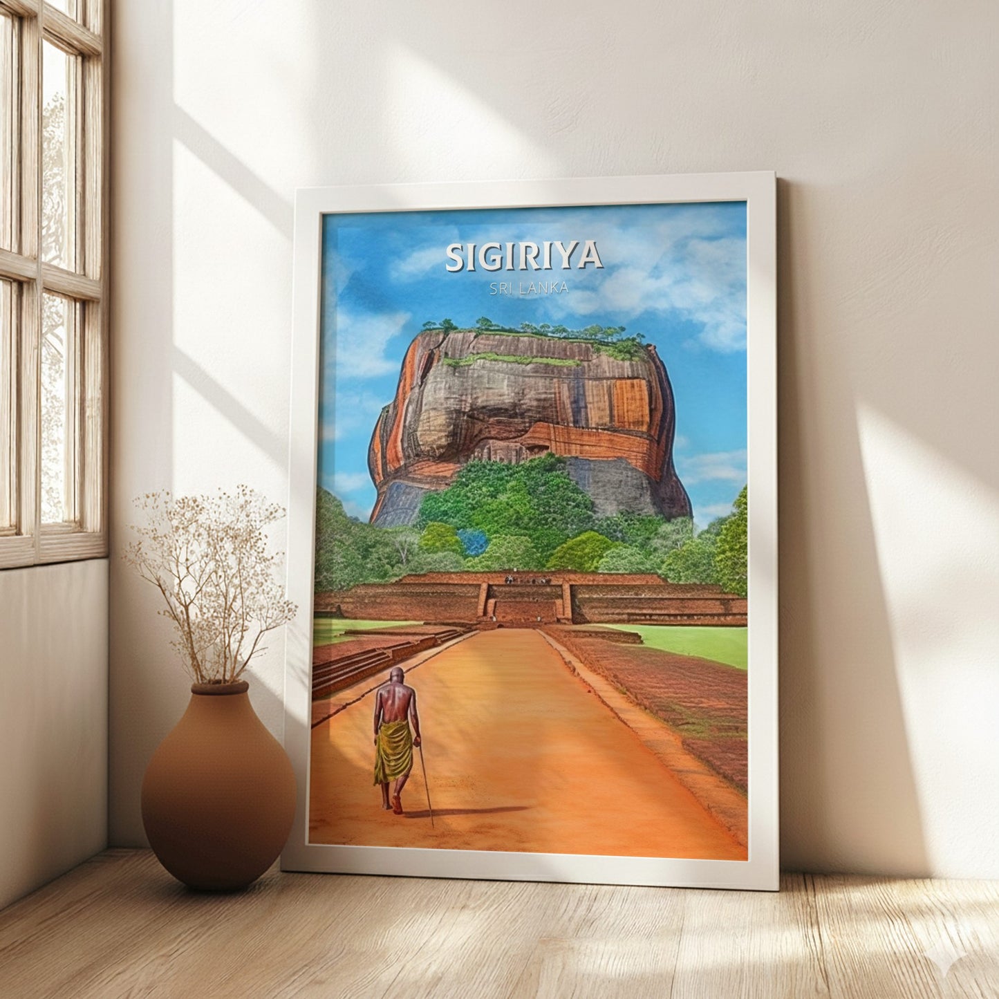 Framed artwork of Sigiriya rock in a room with a vase and window.