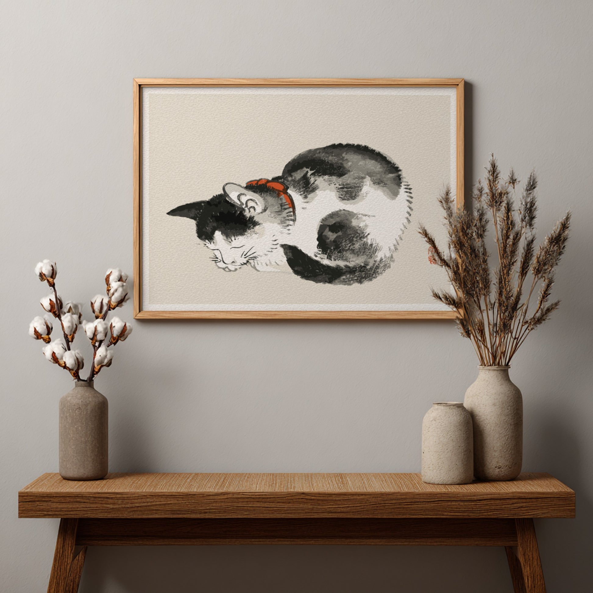 Framed Japanese ink wash drawing of a sleeping black and white cat with a red collar, by Kono Bairei.