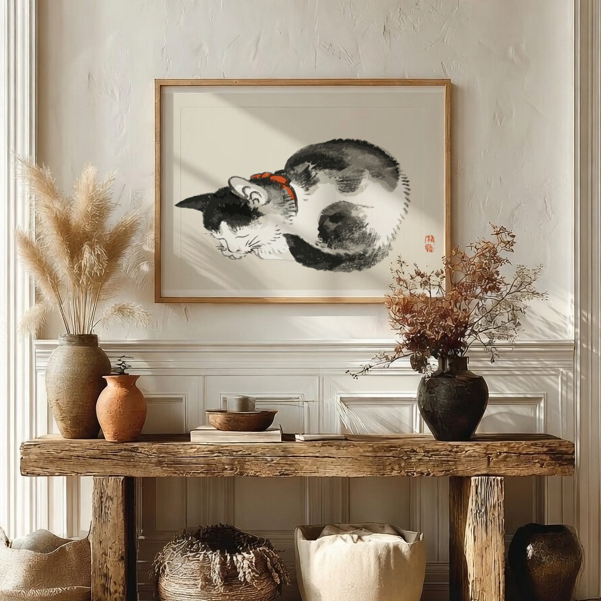 Framed Japanese ink wash drawing of a sleeping black and white cat with a red collar, by Kono Bairei.