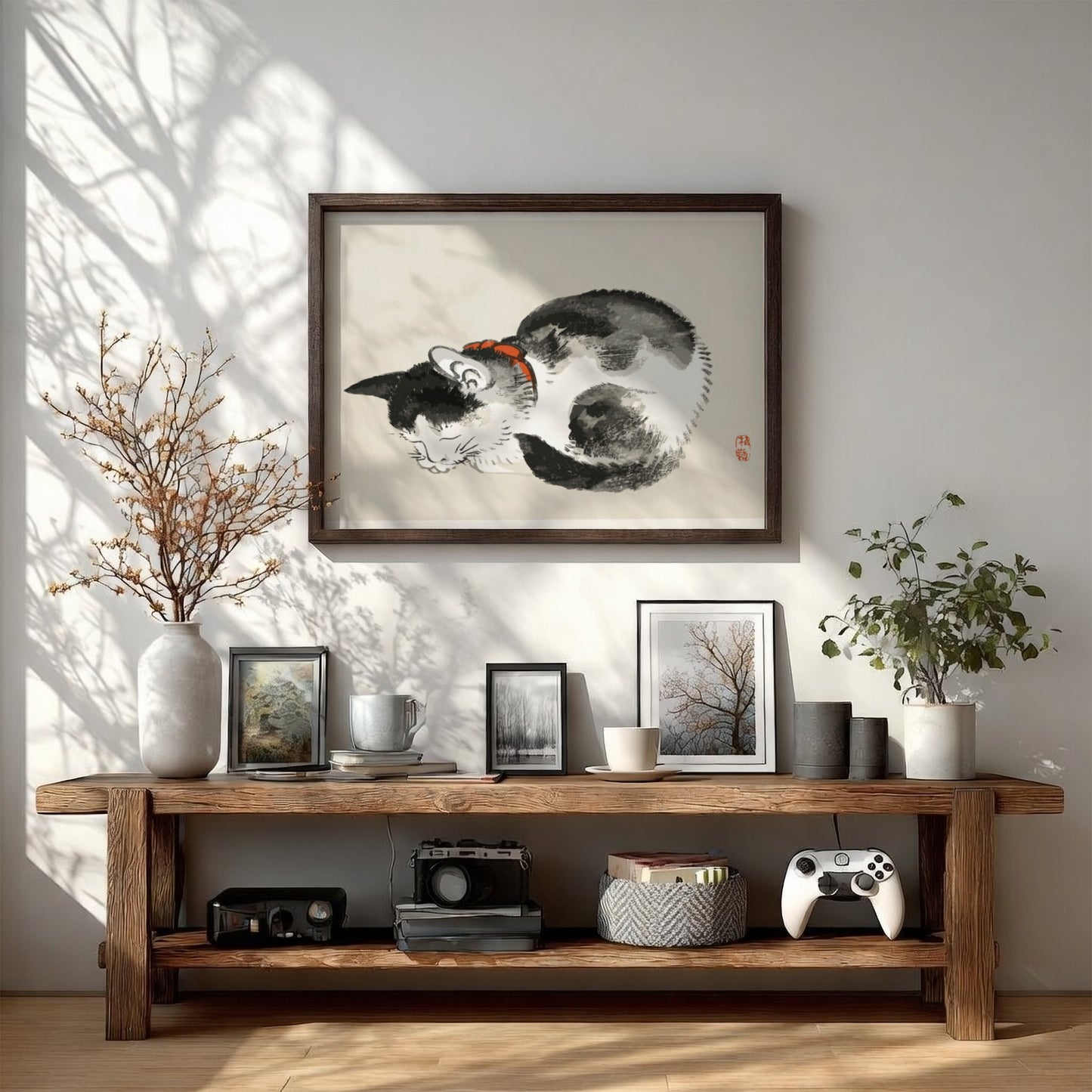 Framed Japanese ink wash drawing of a sleeping black and white cat with a red collar, by Kono Bairei.