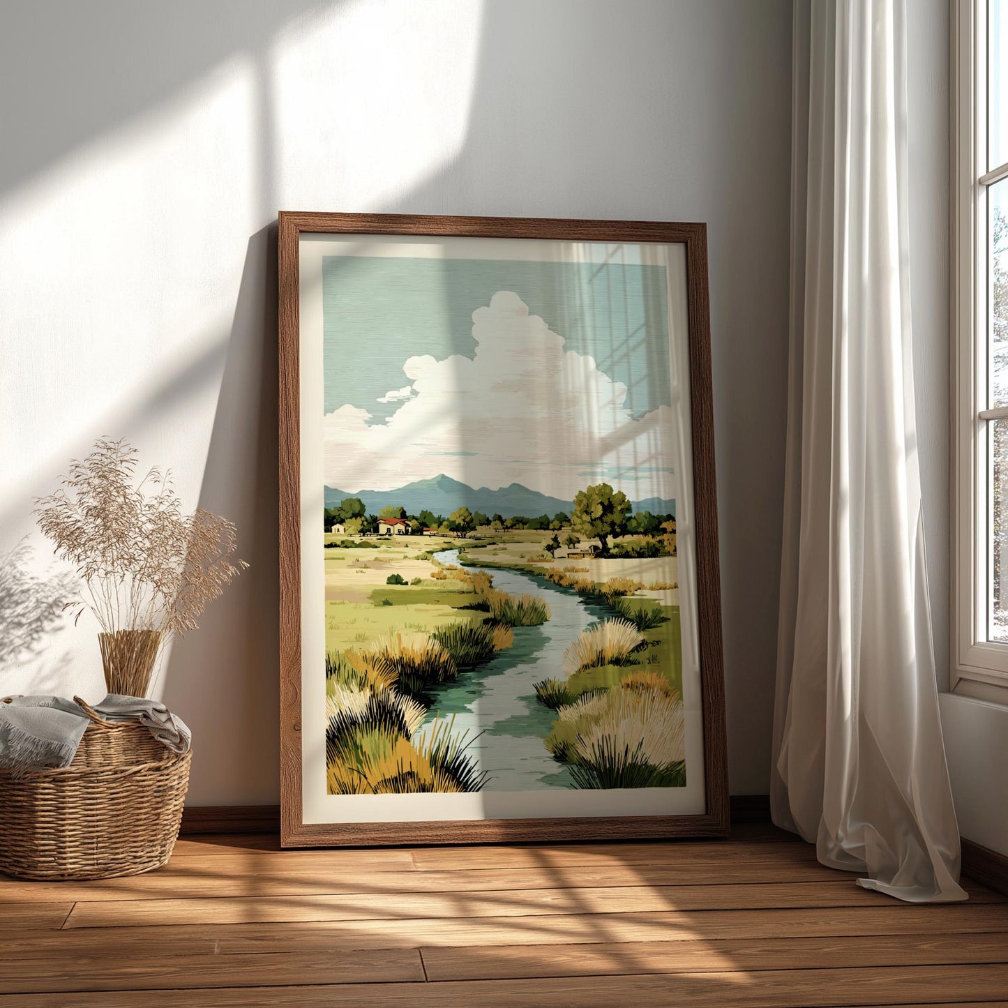 Framed landscape painting on a wall with natural light casting shadows.