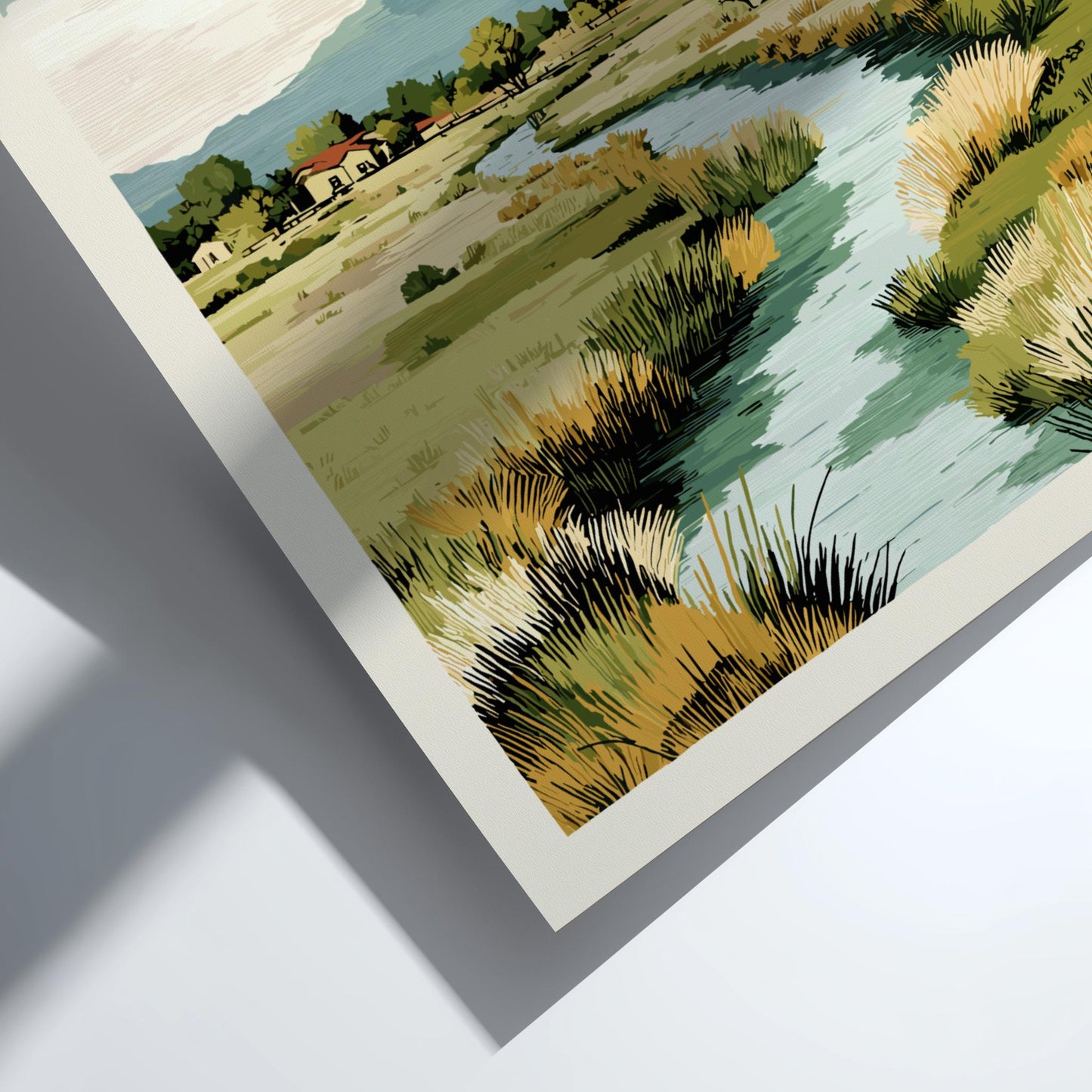 Framed artwork of a landscape with fields and trees on a white surface