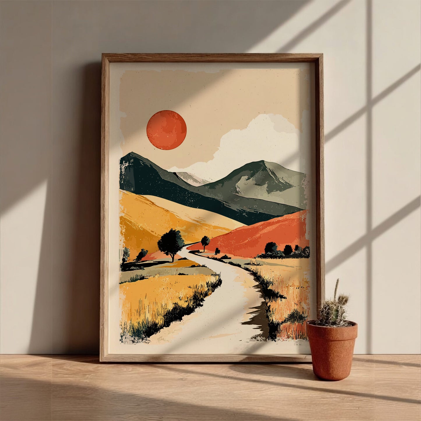Framed abstract landscape art on a wall with natural light