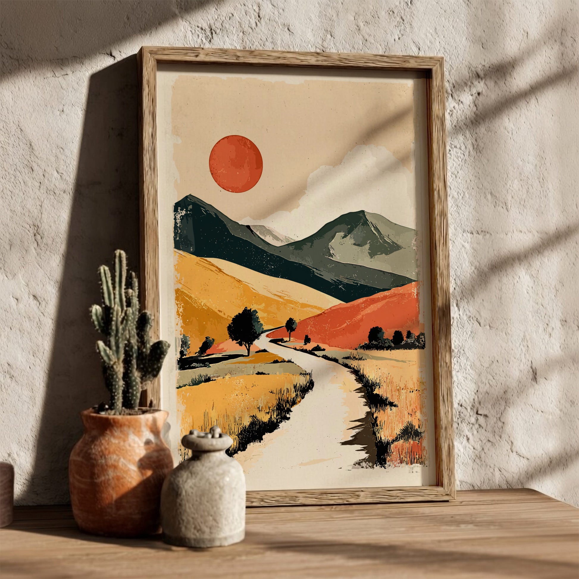 Framed abstract landscape art on a wall with natural light