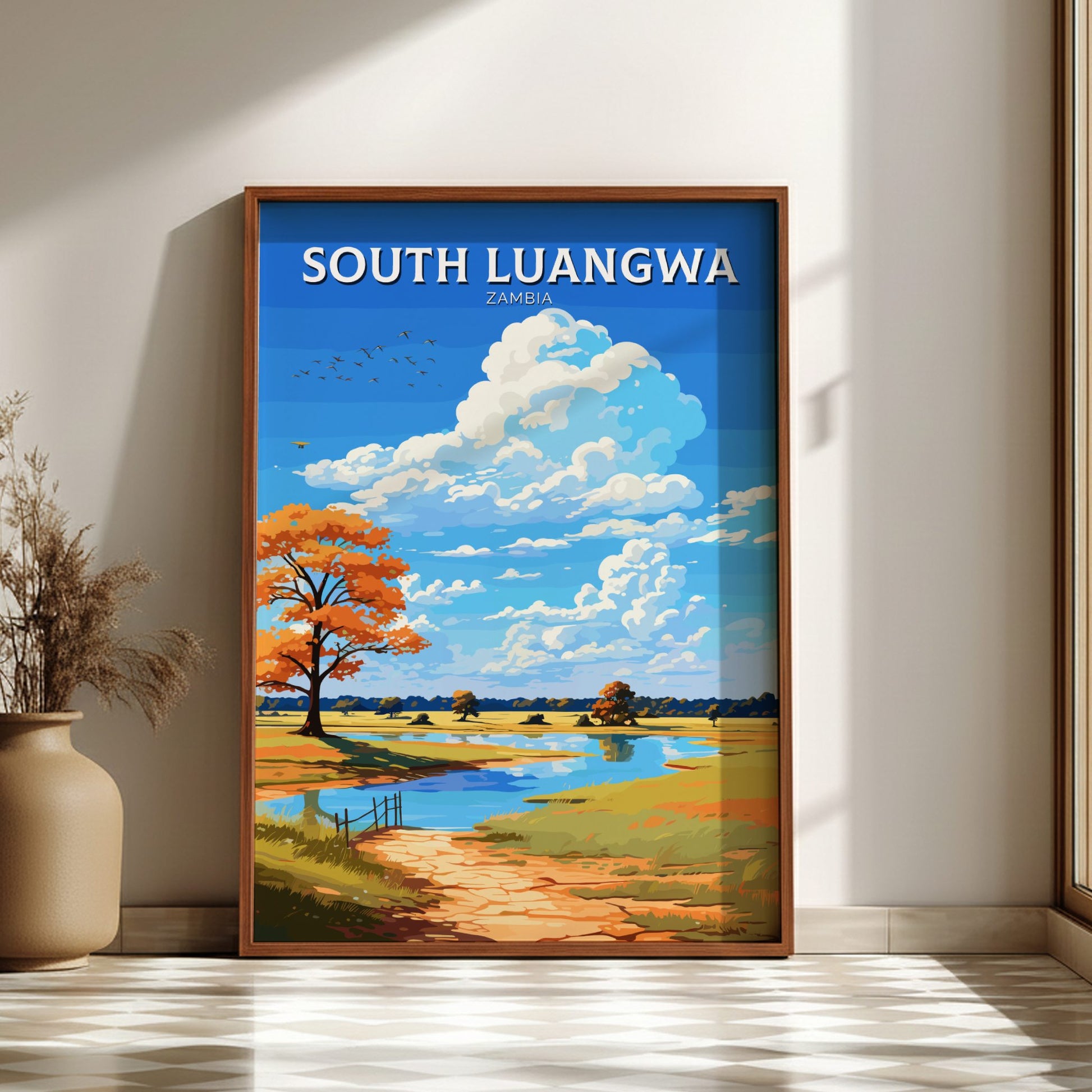 Framed artwork of South Luangwa landscape with a blue sky and trees, displayed on a wall.