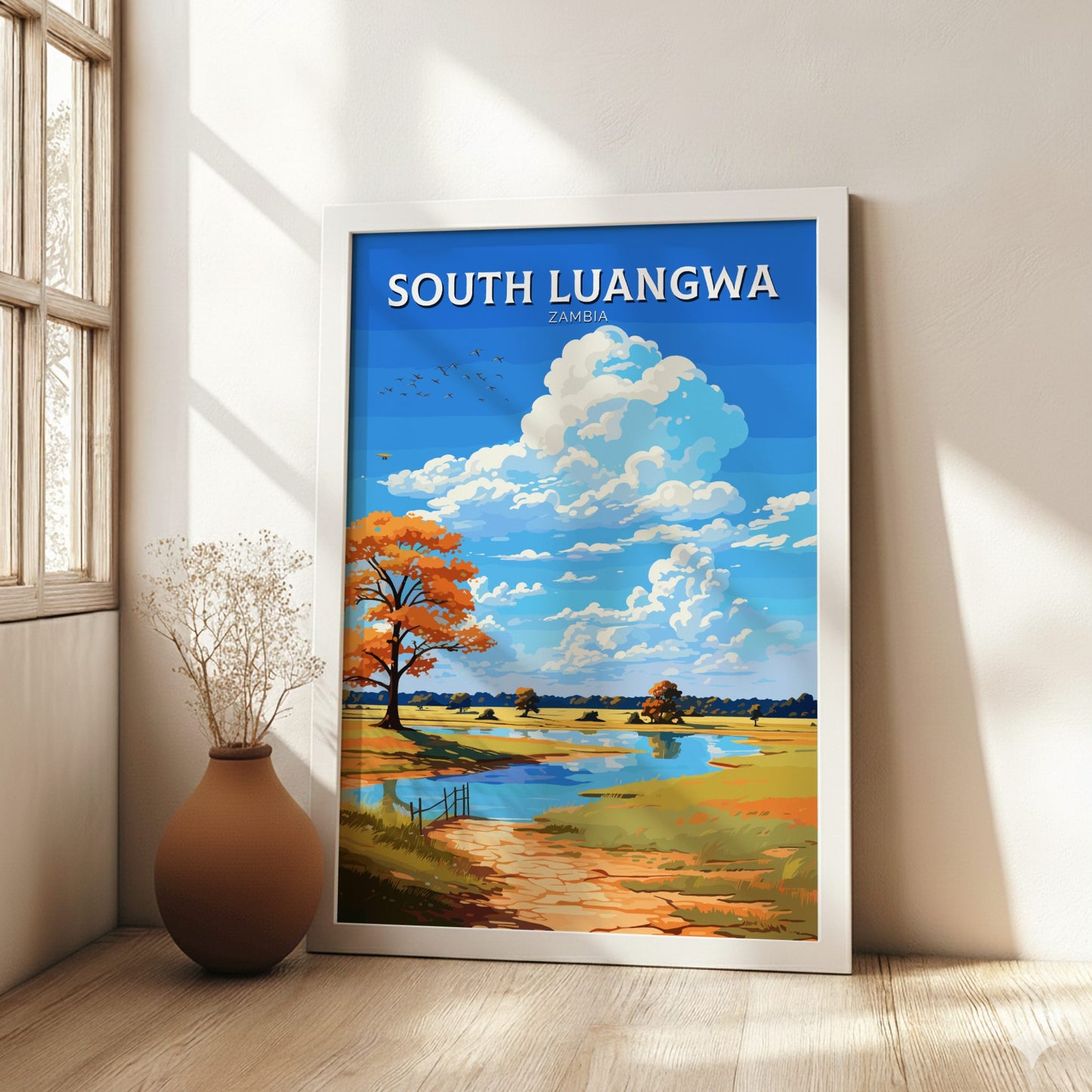 Framed artwork of South Luangwa, Zambia with a scenic landscape on a wall.