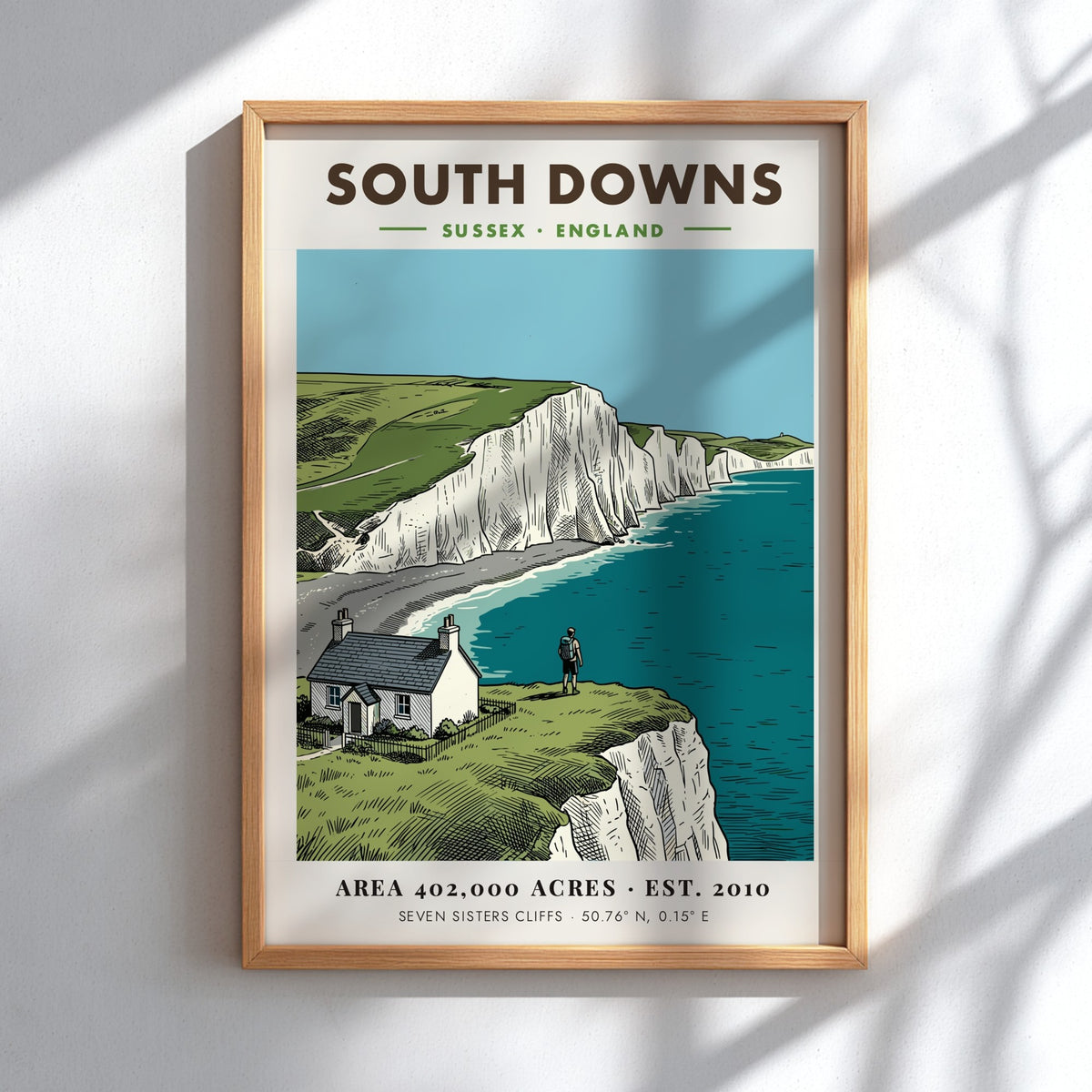 Poster of South Downs National Park featuring white cliffs, a cottage, and hiker.
