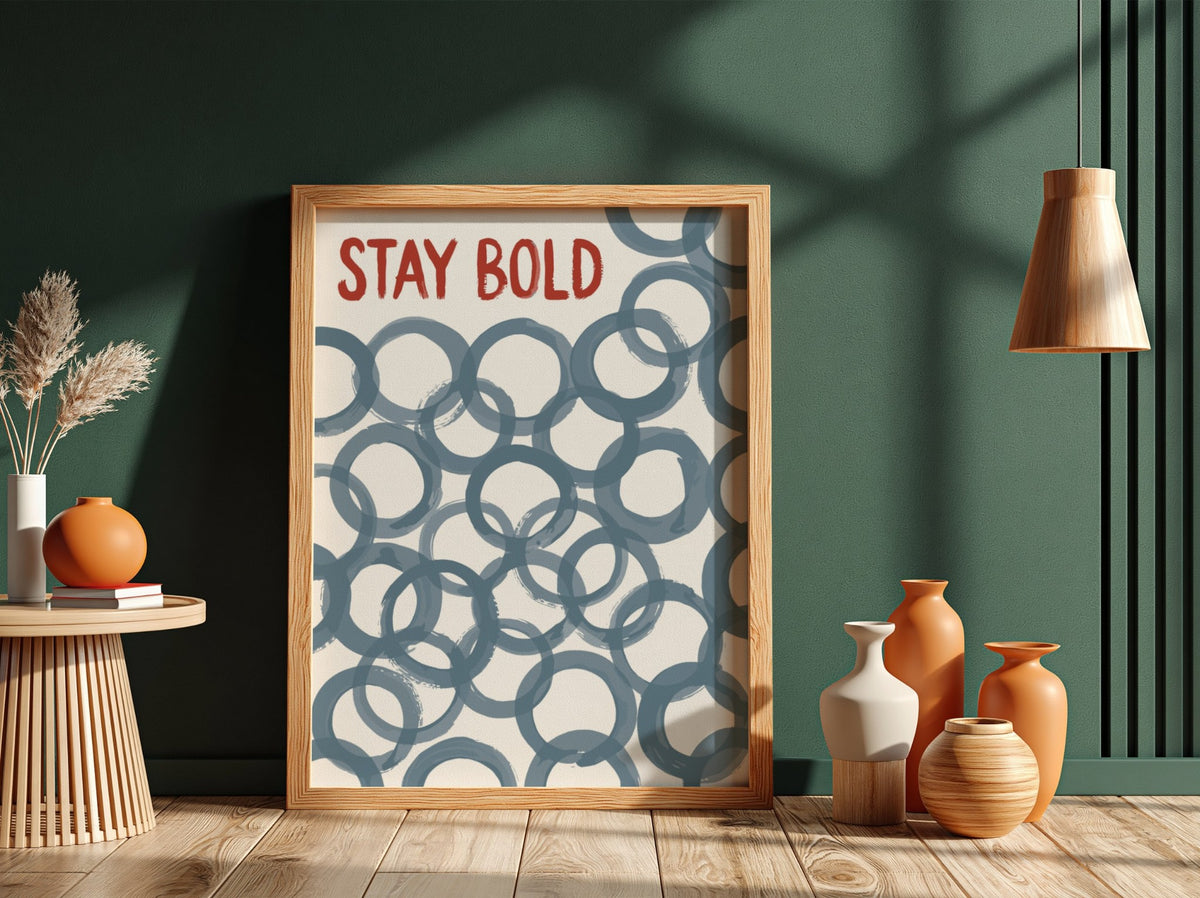 Motivational poster with Stay Bold text in orange over slate blue circle patterns.