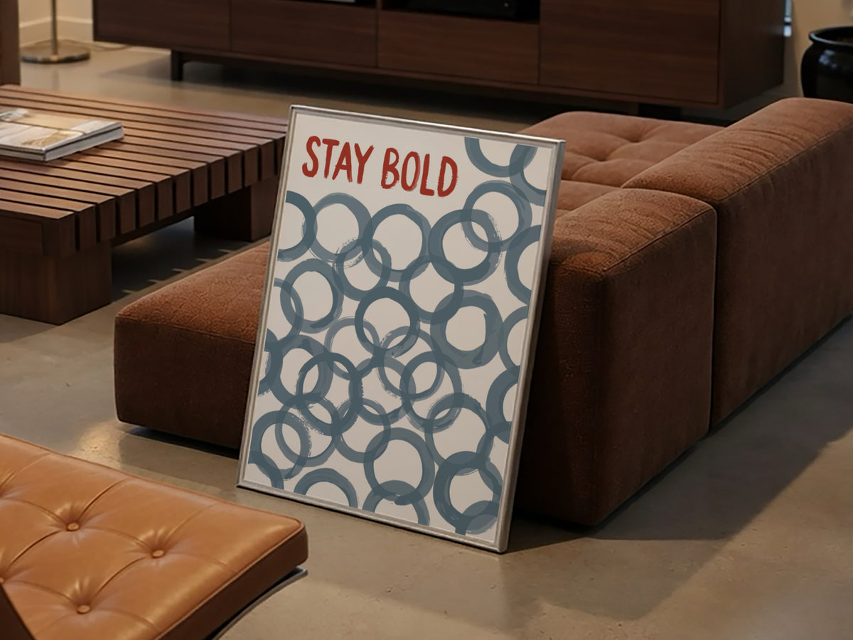 Motivational poster with Stay Bold text in orange over slate blue circle patterns.