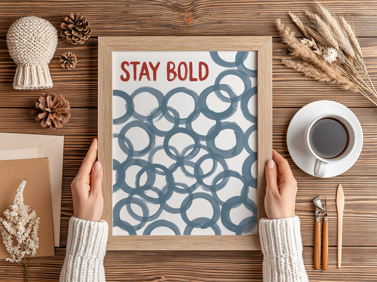 Motivational poster with Stay Bold text in orange over slate blue circle patterns.