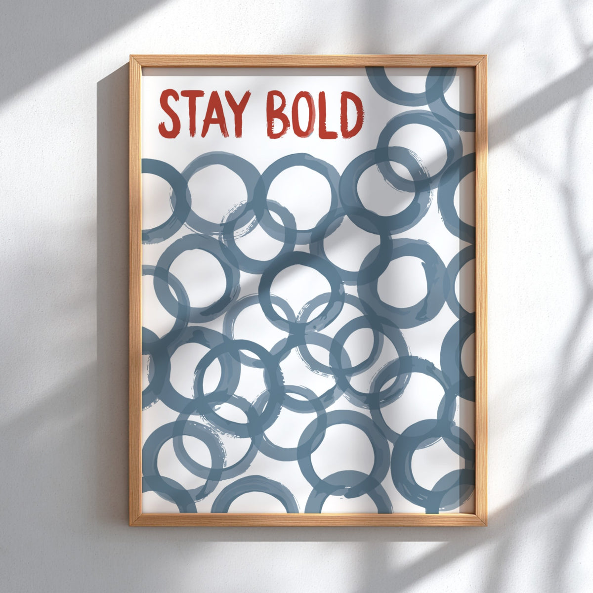 Motivational poster with Stay Bold text in orange over slate blue circle patterns.