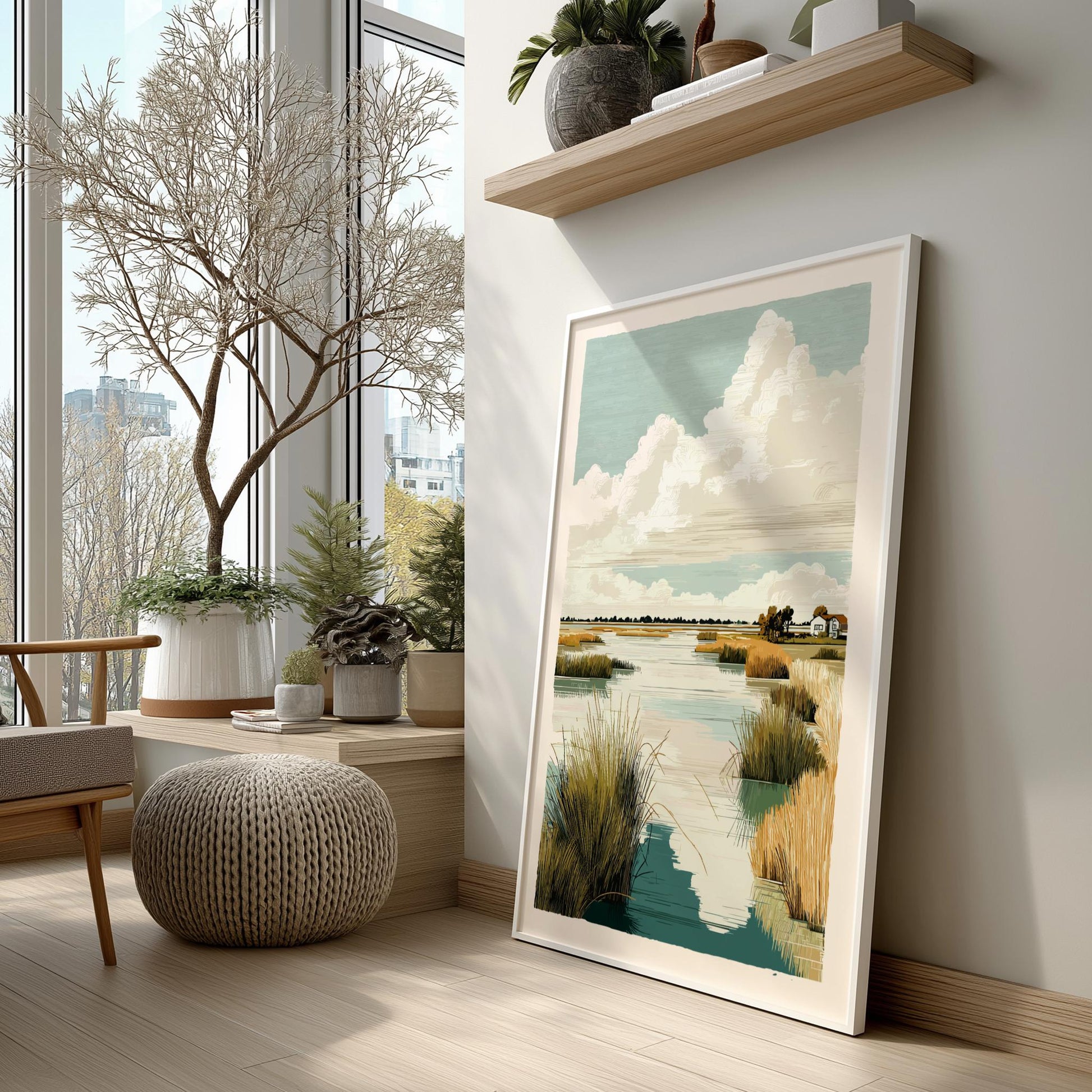 Framed artwork of a landscape with water and sky, placed on a wall in a room with plants and furniture.