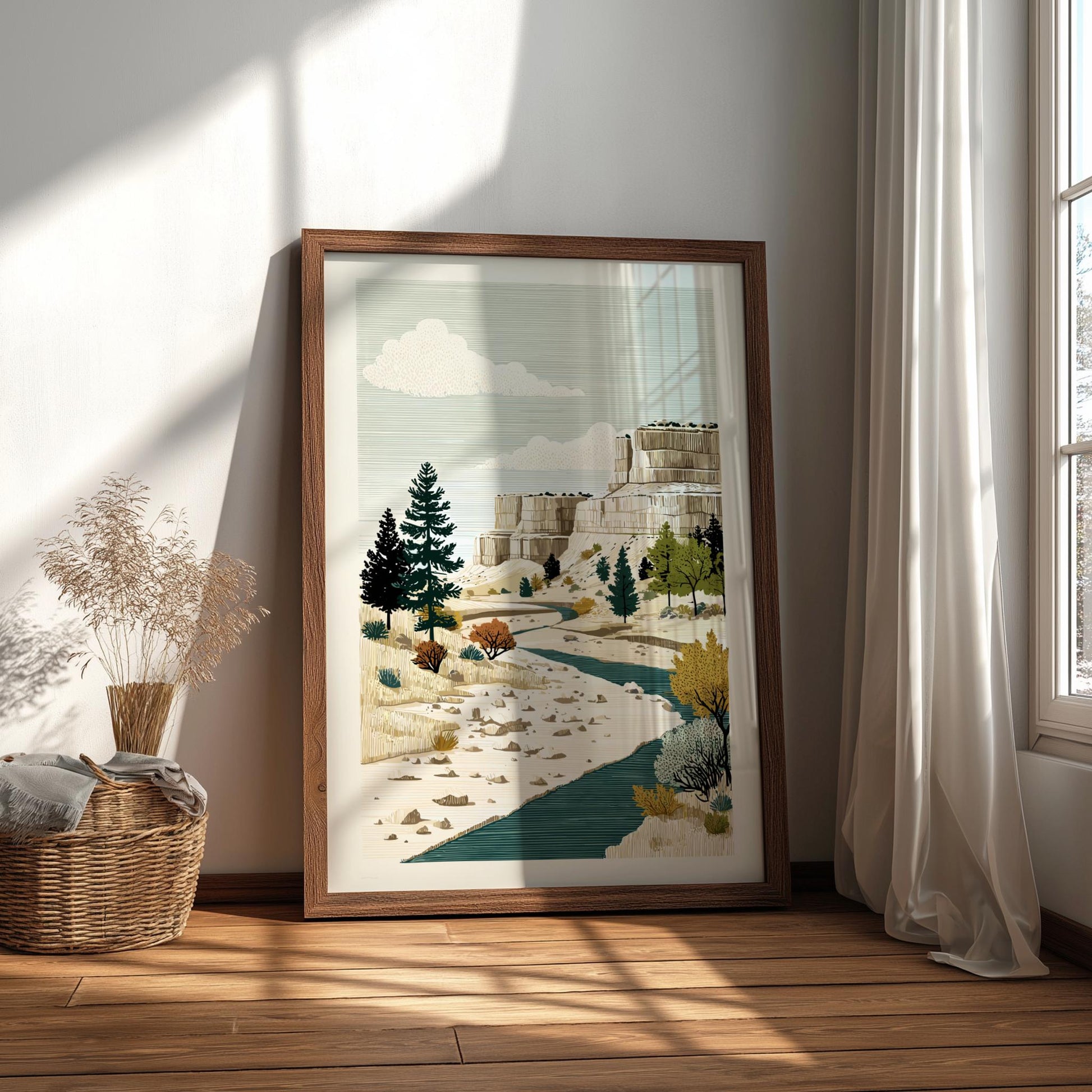Framed artwork of a landscape with trees and a building in a bright room.