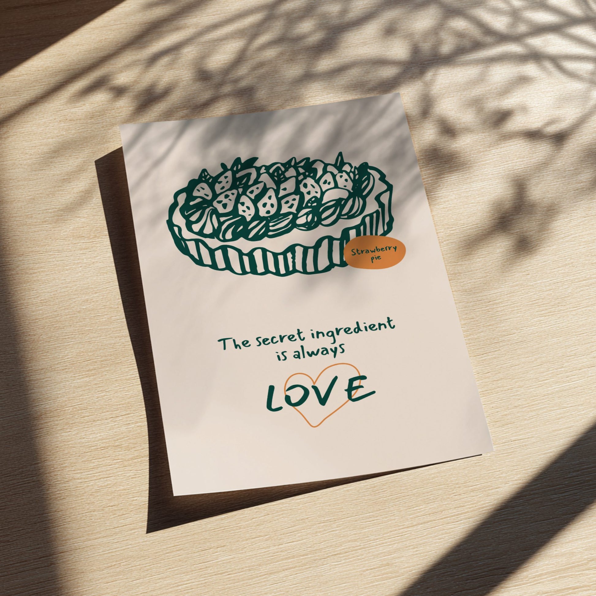Card with a strawberry tart illustration and text on a wooden surface