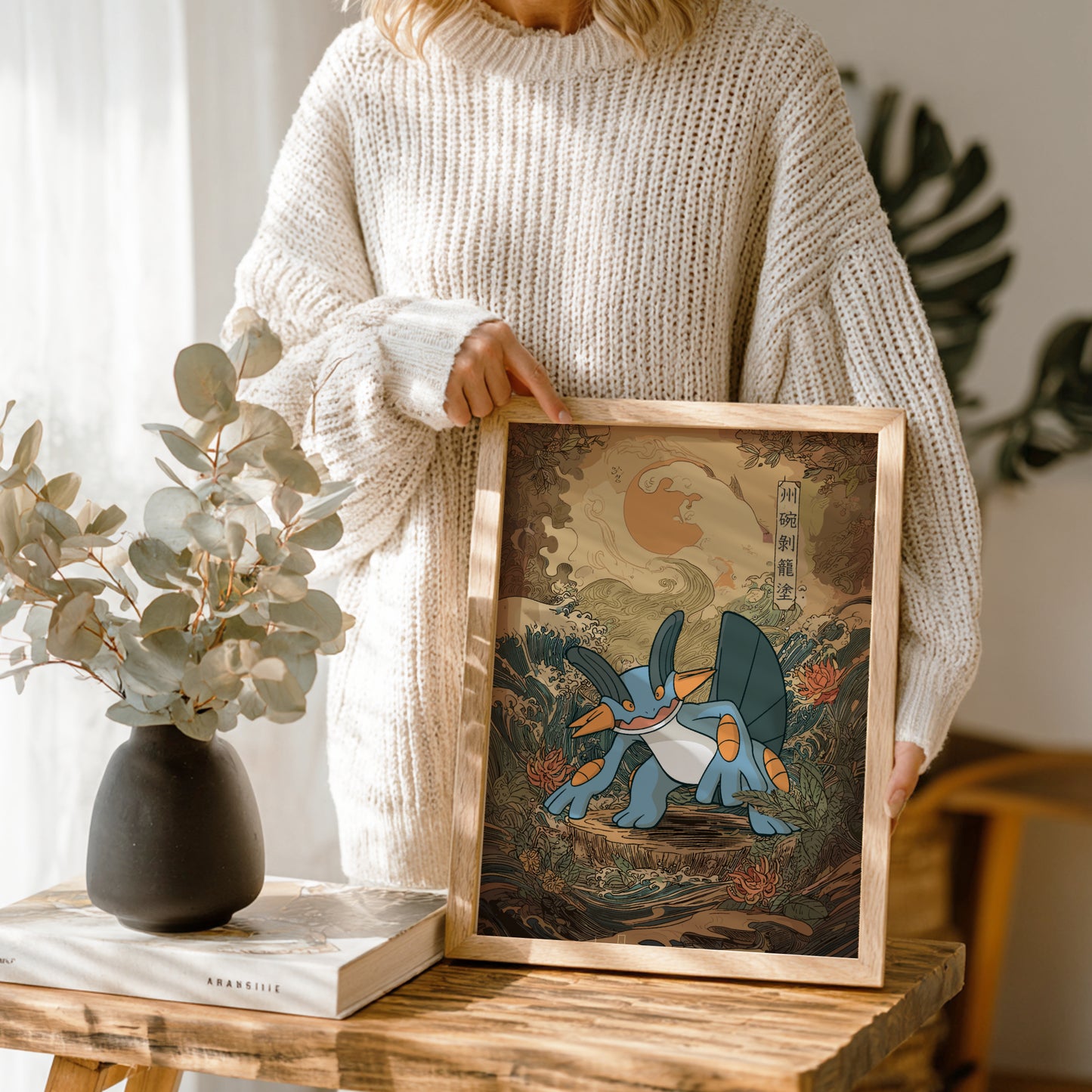 Person holding a framed artwork of Swampert Pokemon in a natural setting.