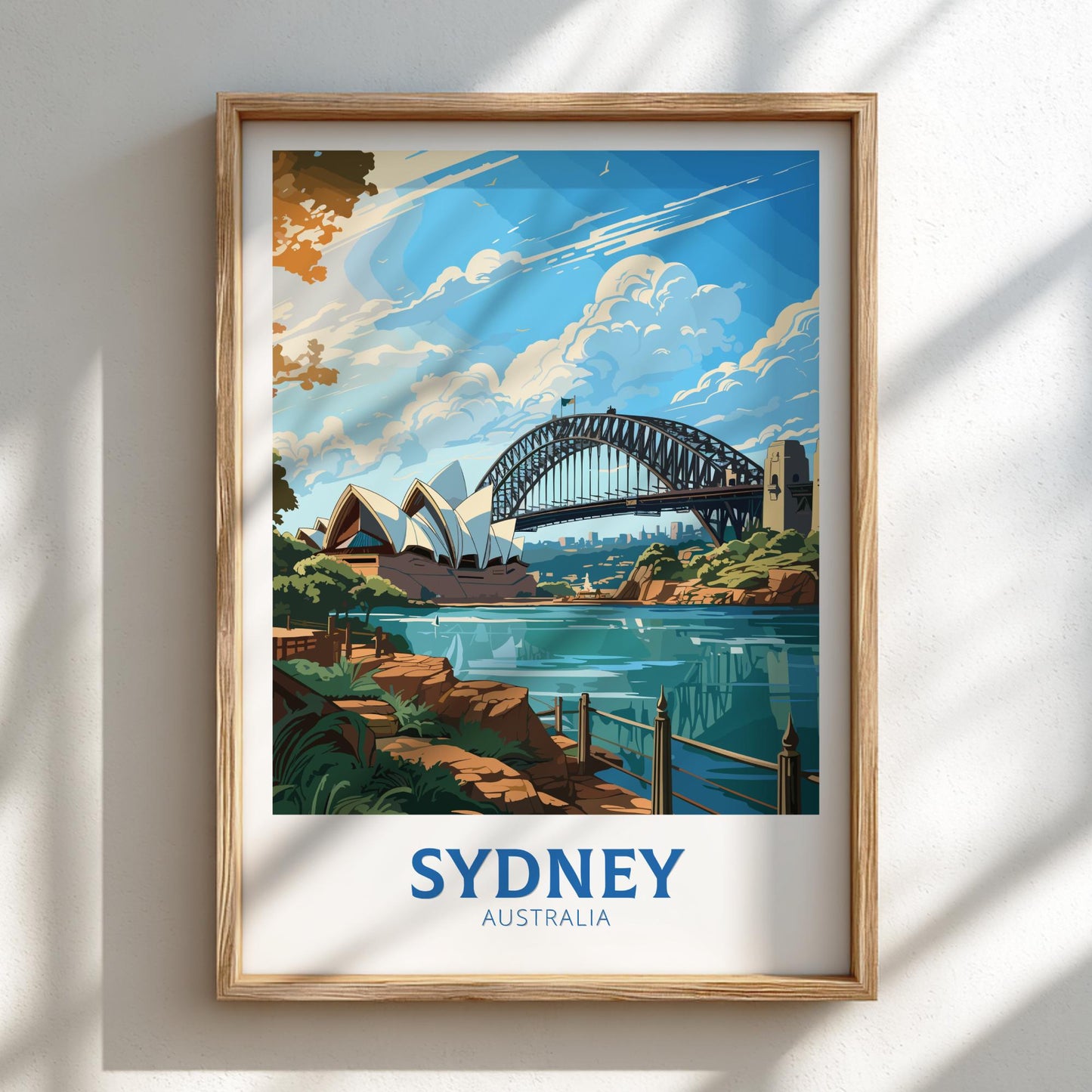 Framed artwork of Sydney Harbour Bridge and Opera House on a white wall.