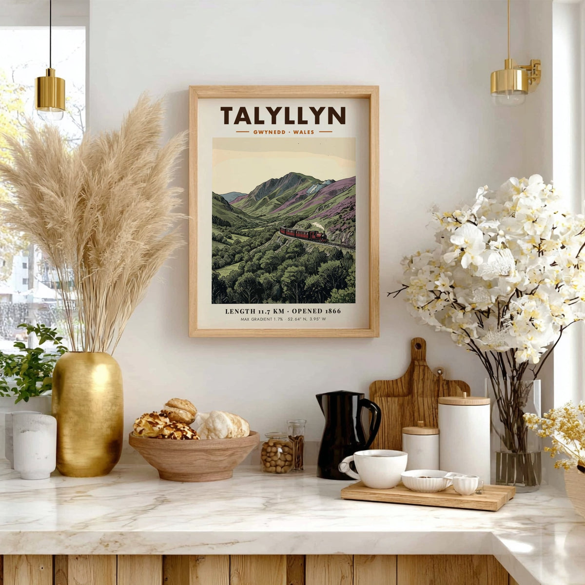 Poster of a red steam train travelling through the mountainous Talyllyn landscape in Wales.