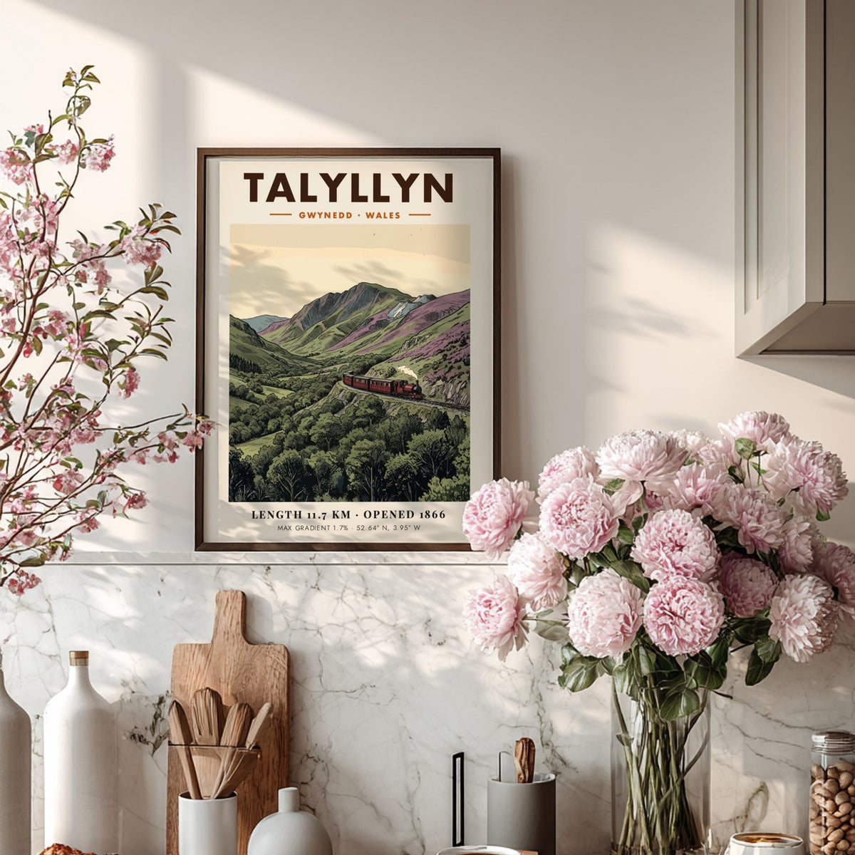 Poster of a red steam train travelling through the mountainous Talyllyn landscape in Wales.