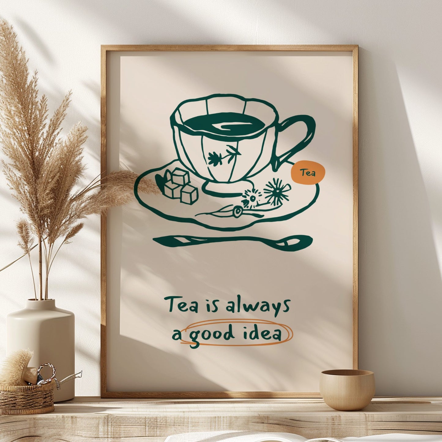 Framed artwork with a tea cup illustration and text on a wall with decorative elements.