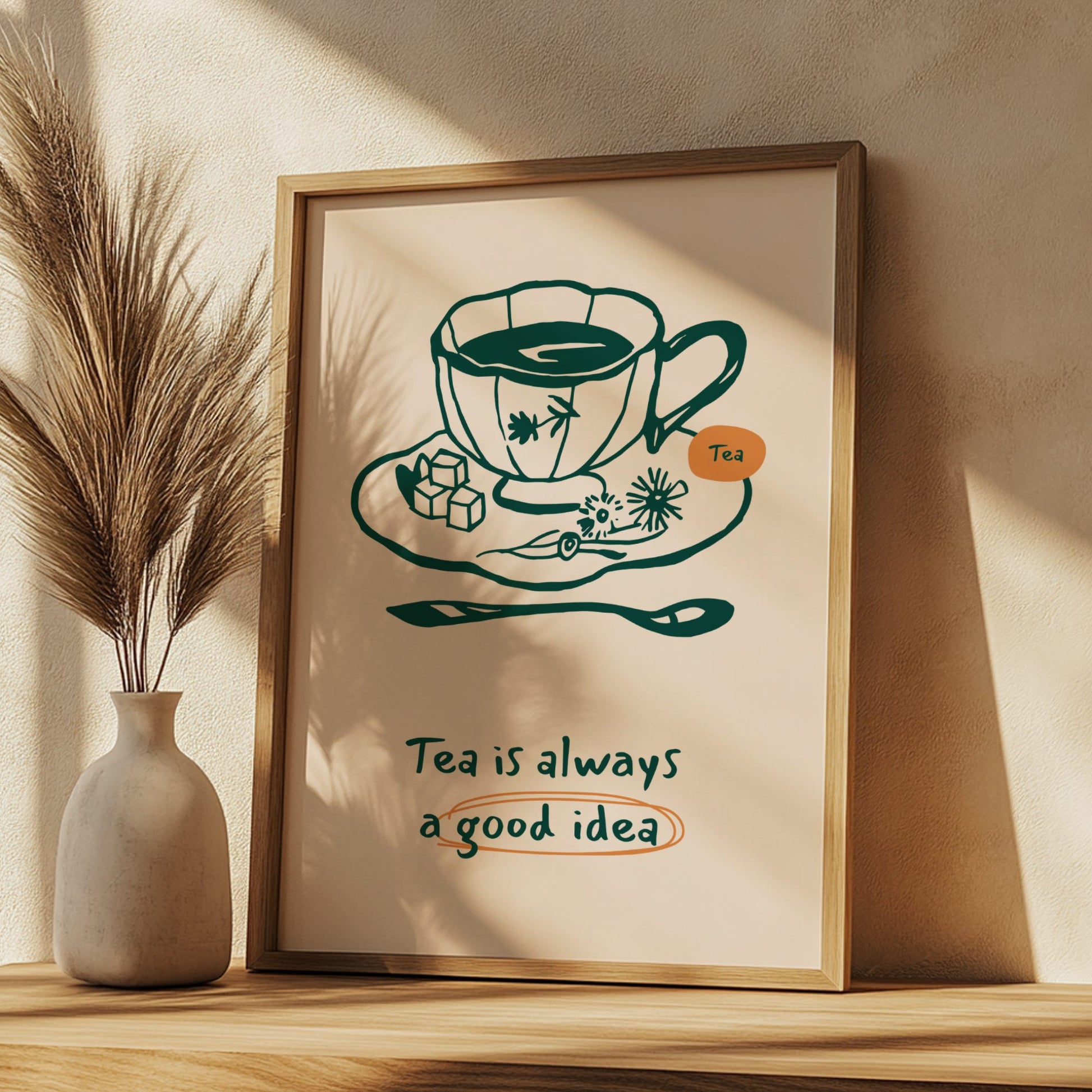 Framed print with a tea cup illustration and text on a wooden shelf.