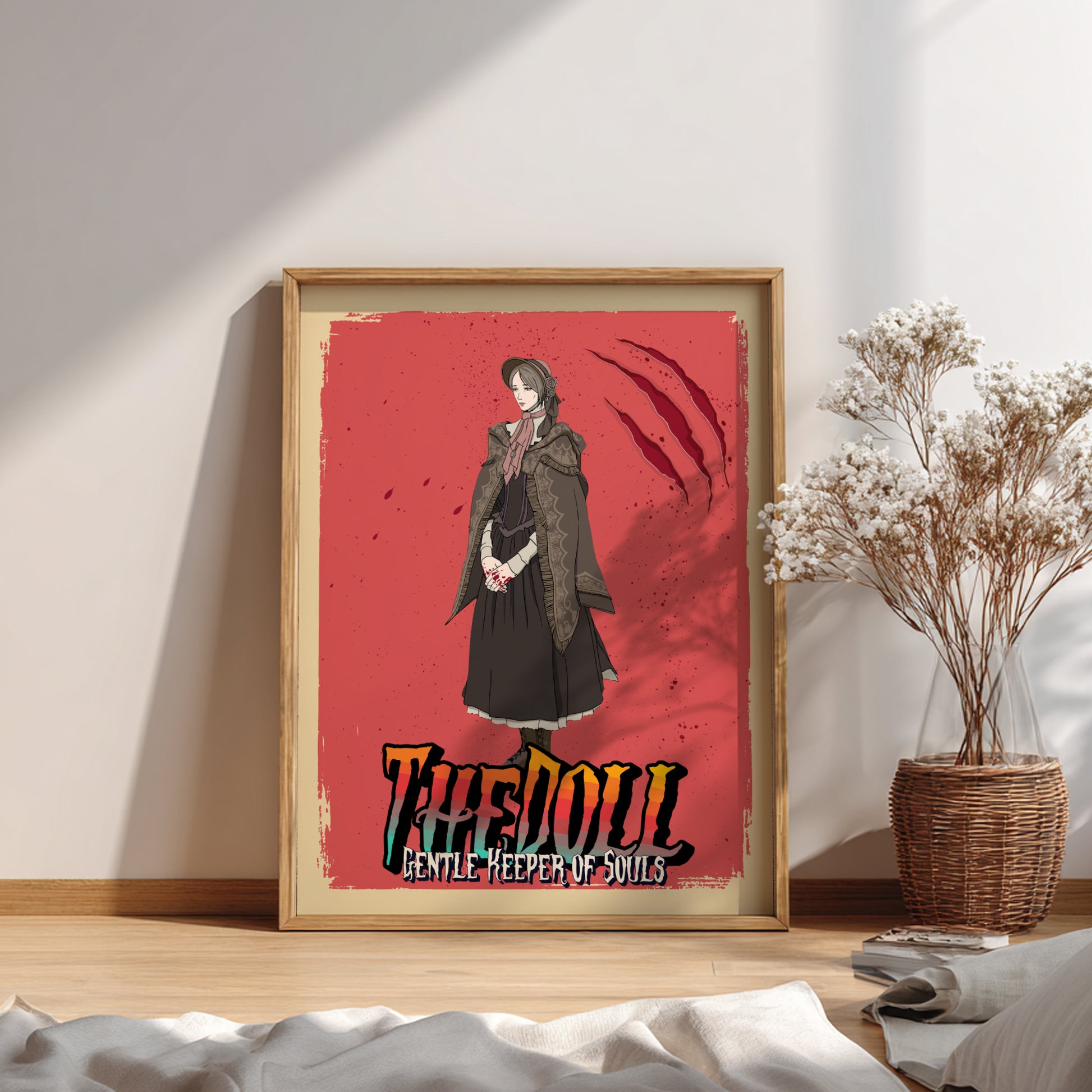 Framed artwork of The Doll from Bloodborne on a red background, placed on a wooden surface.