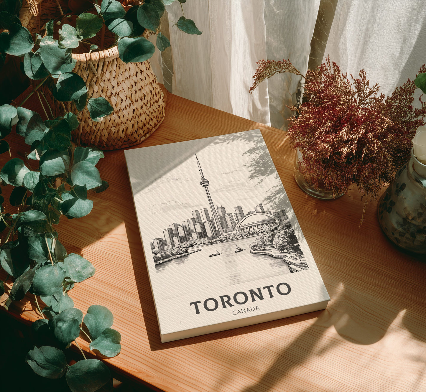 Canvas 'Toronto, Canada' on a wooden table with plants