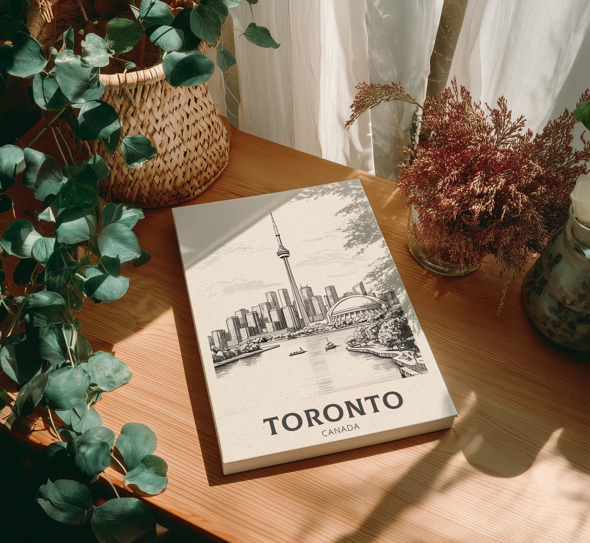 Canvas 'Toronto, Canada' on a wooden table with plants