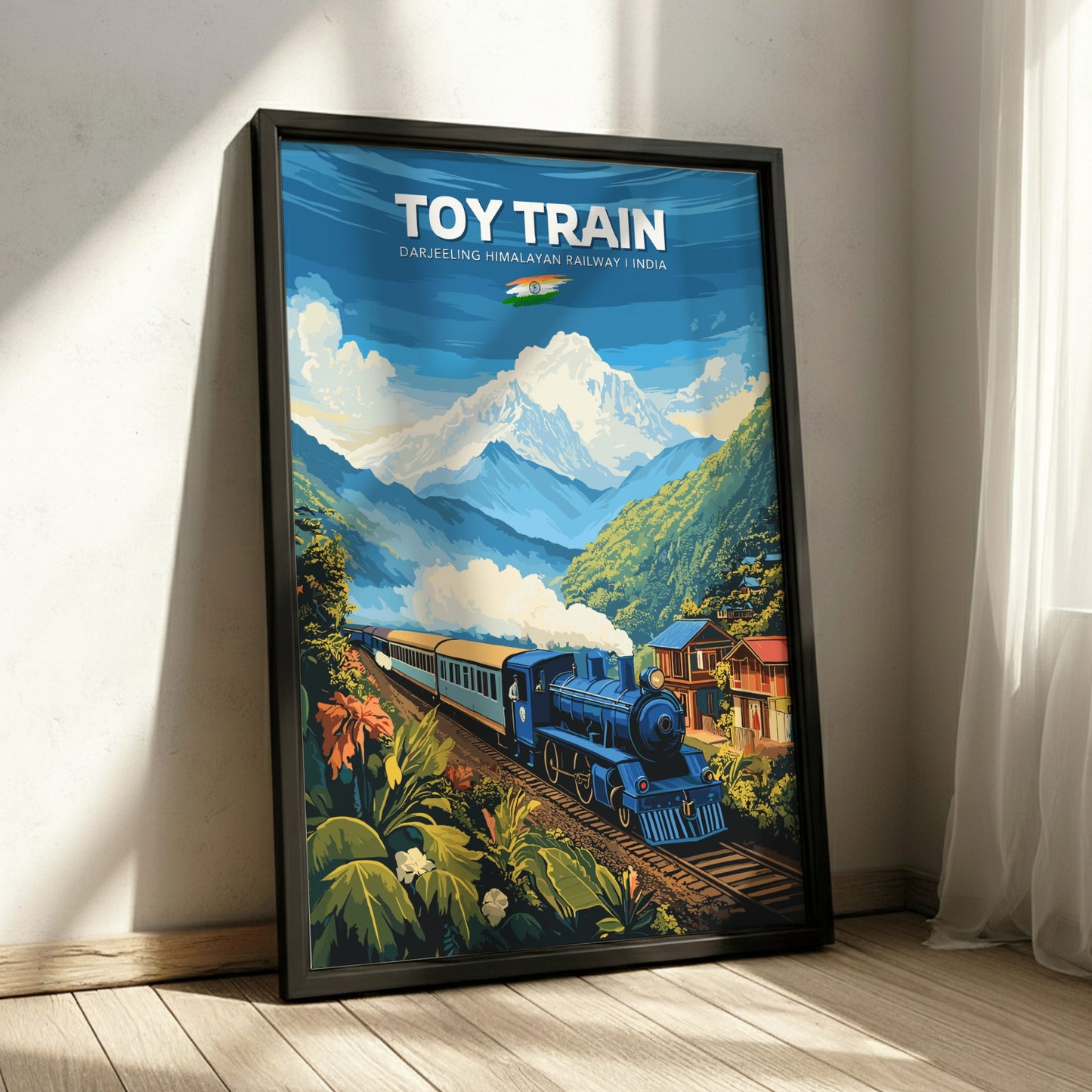 Framed poster of a toy train in a mountainous landscape on a wall.