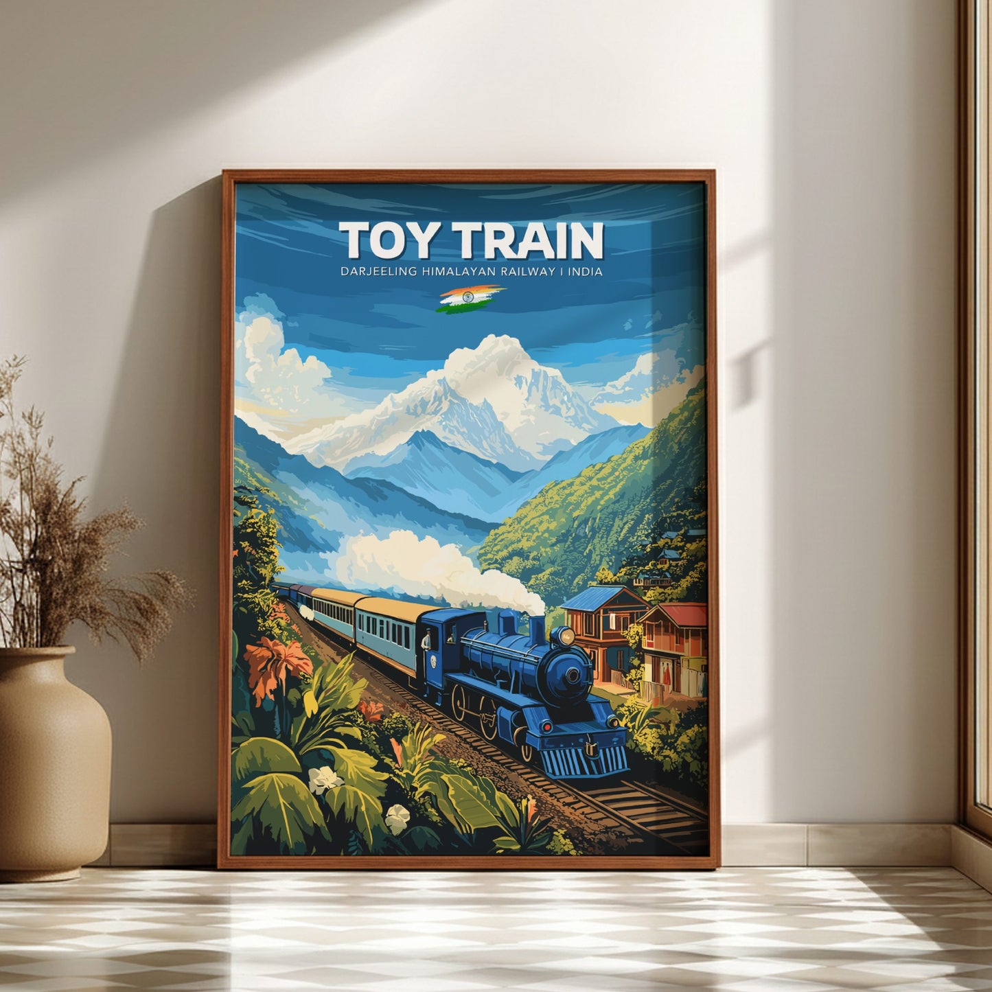 Framed poster of a toy train in a mountainous landscape on a wall.
