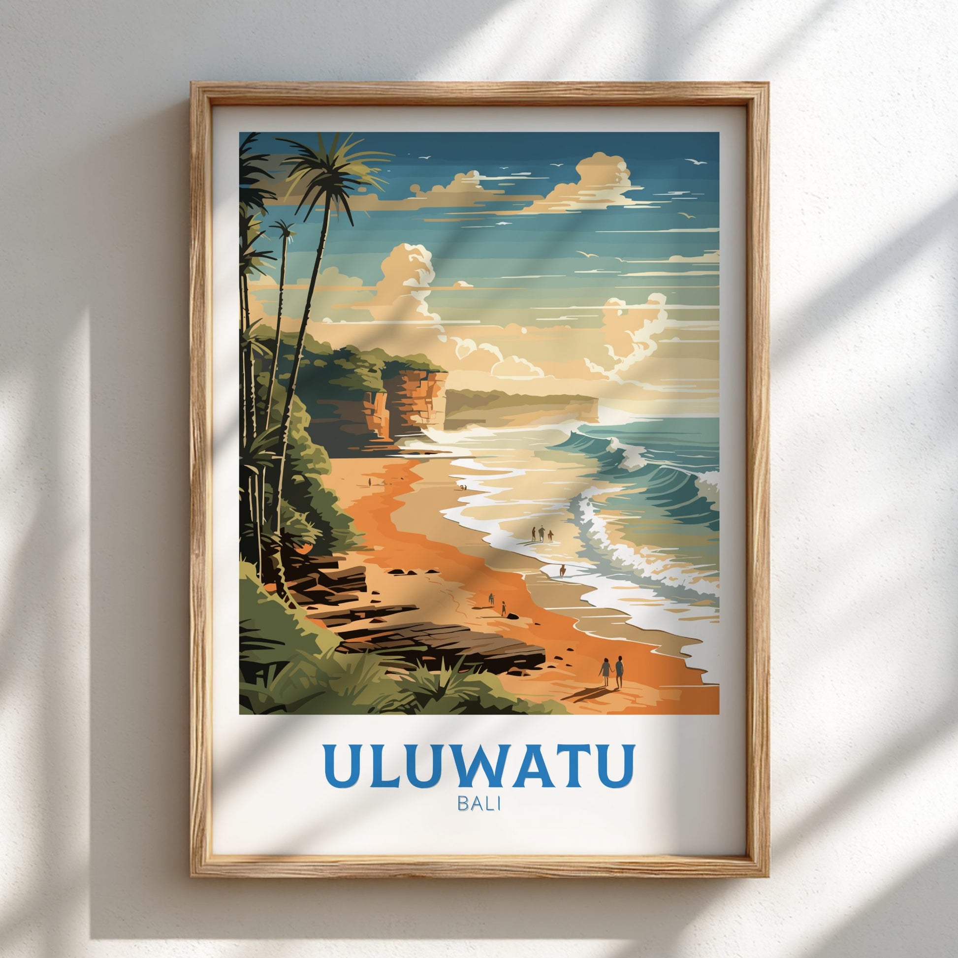 Framed artwork of a beach scene with 'Uluwatu Bali' text on a white wall.