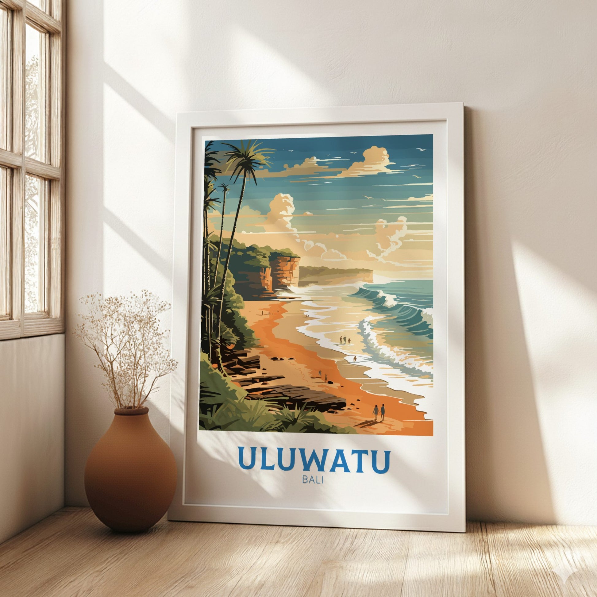 Framed artwork of Uluwatu Bali beach in a room with a vase and window.