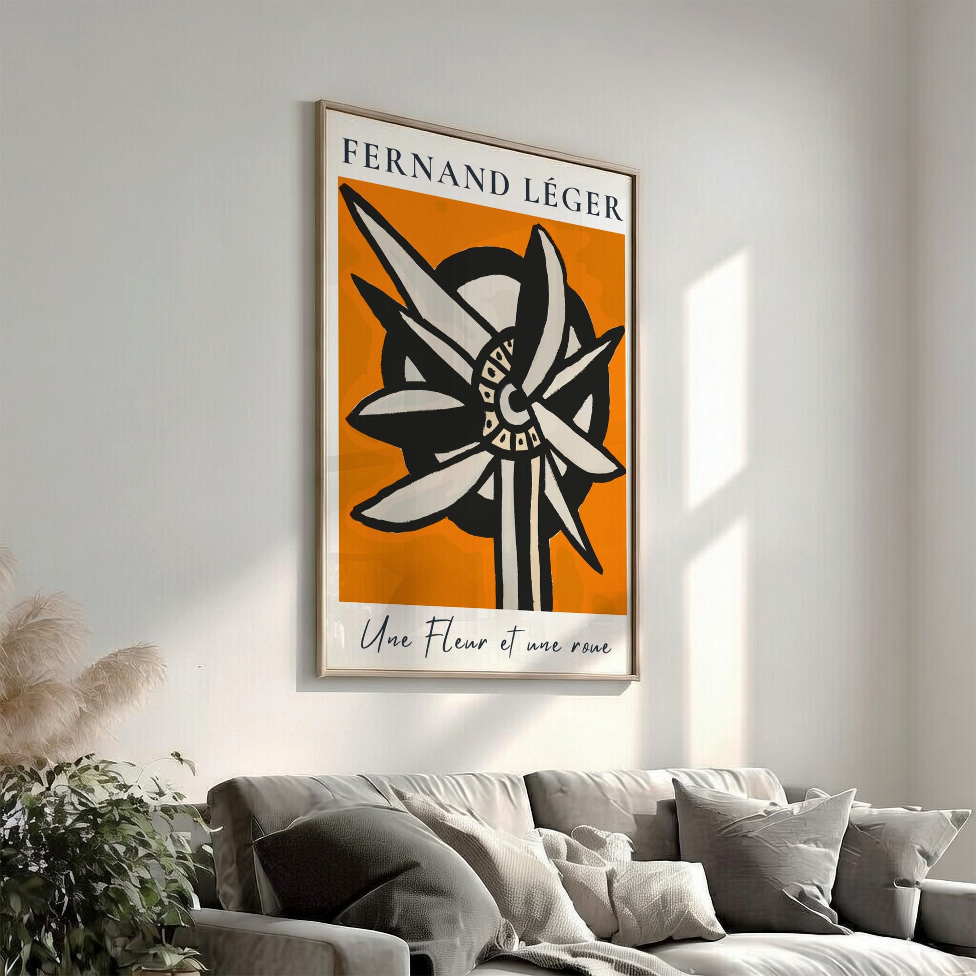 Fernand Léger "Une Fleur et une roue" poster with abstract flower/wheel design on orange background.