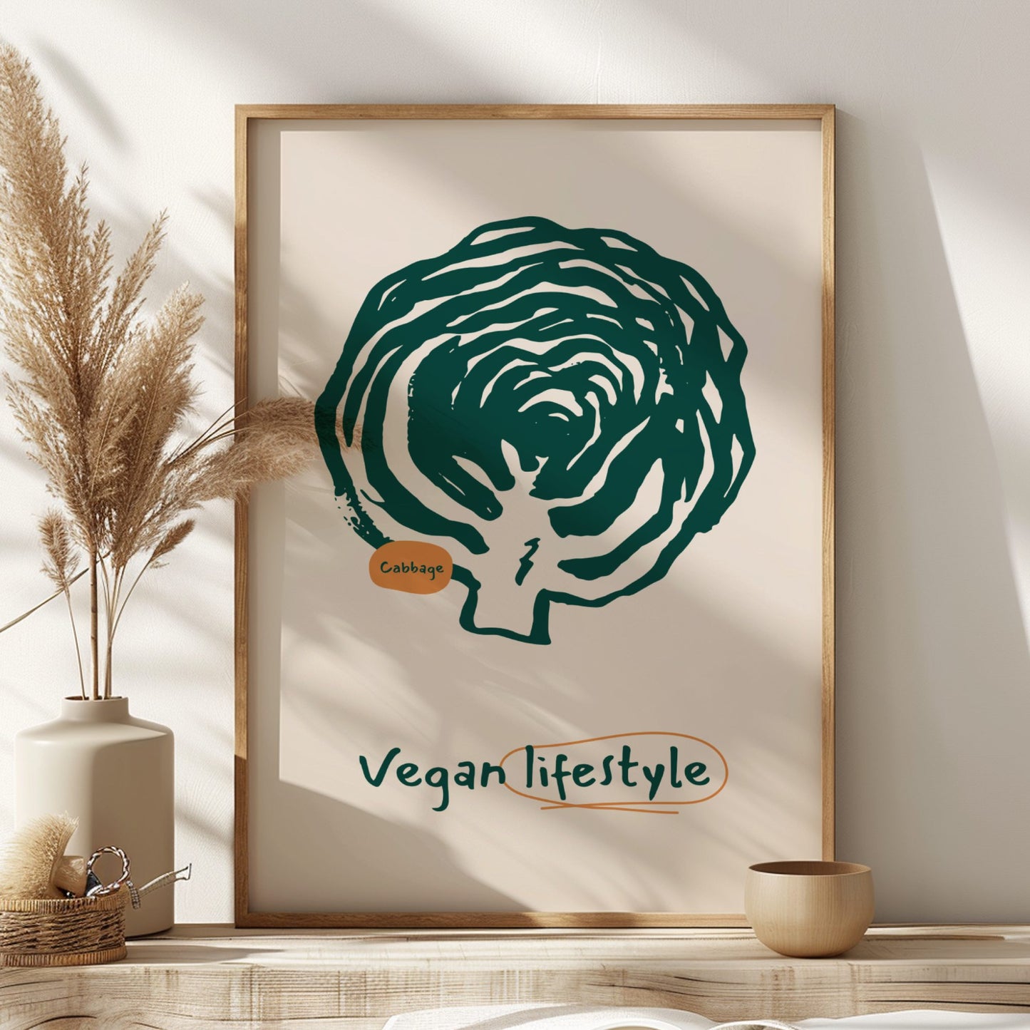 Framed artwork of a cabbage with 'Vegan lifestyle' text on a wall.