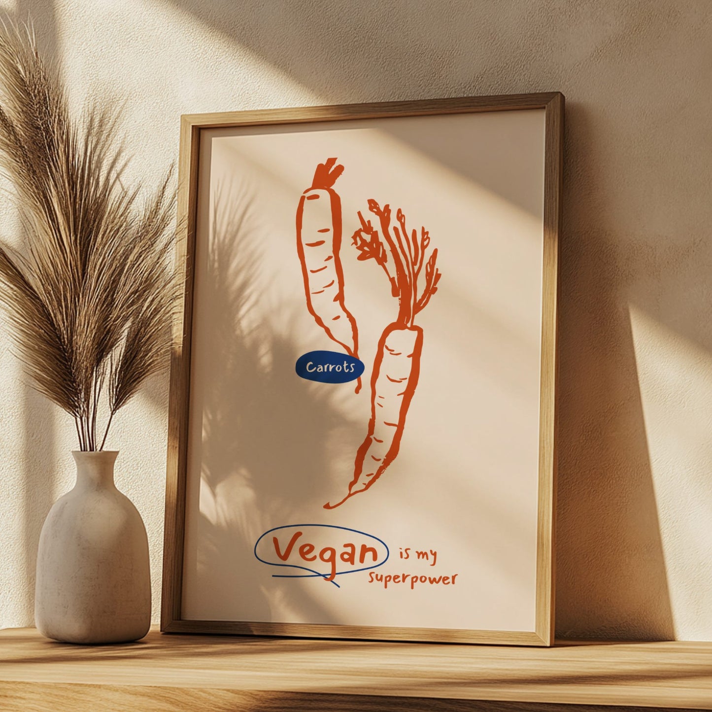 Framed artwork with carrots and 'Vegan is my Superpower' text on a beige wall.