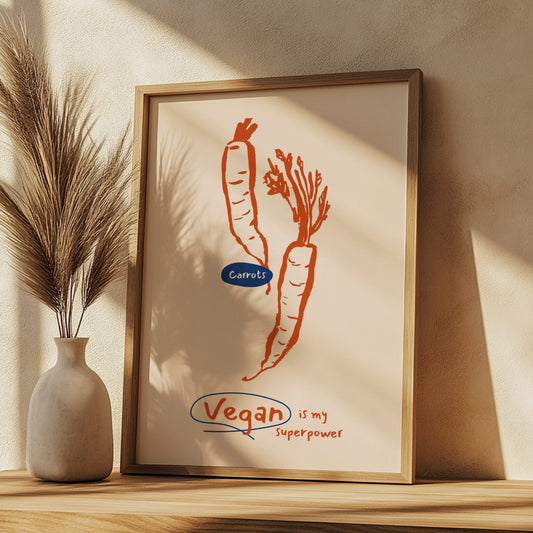 Framed artwork with carrots and 'Vegan is my Superpower' text on a beige wall.
