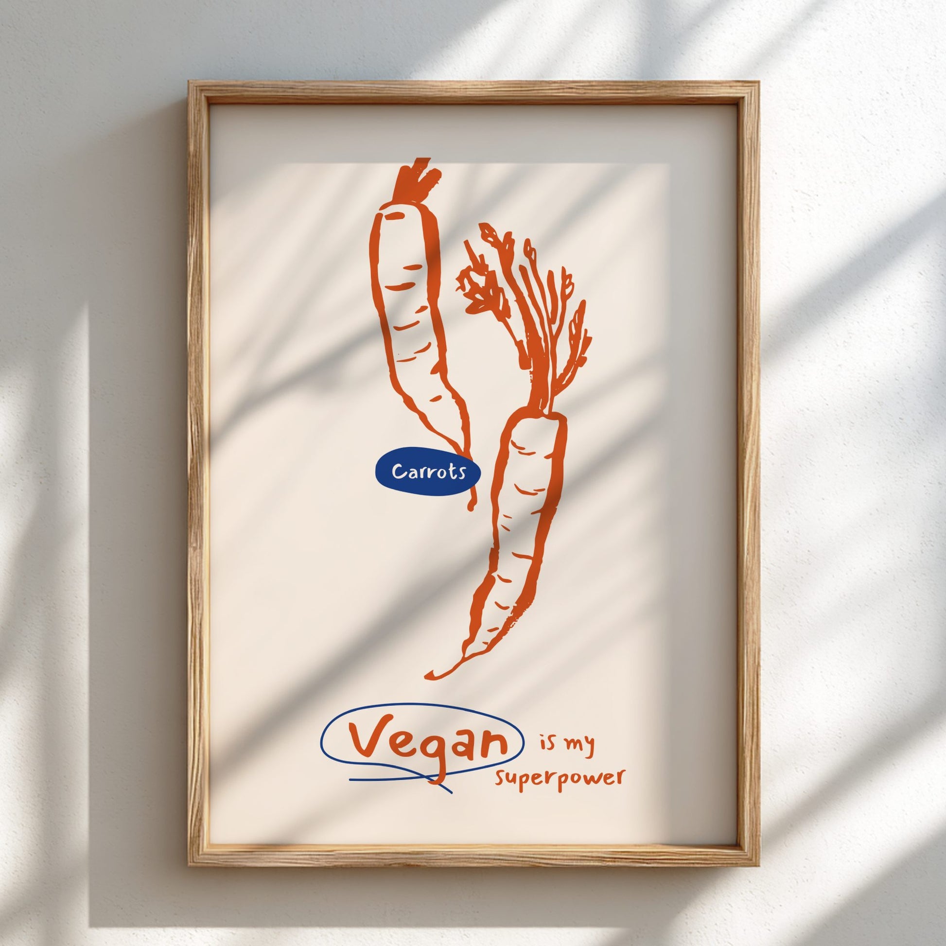 Framed artwork with carrots and 'Vegan is my superpower' text on a light background
