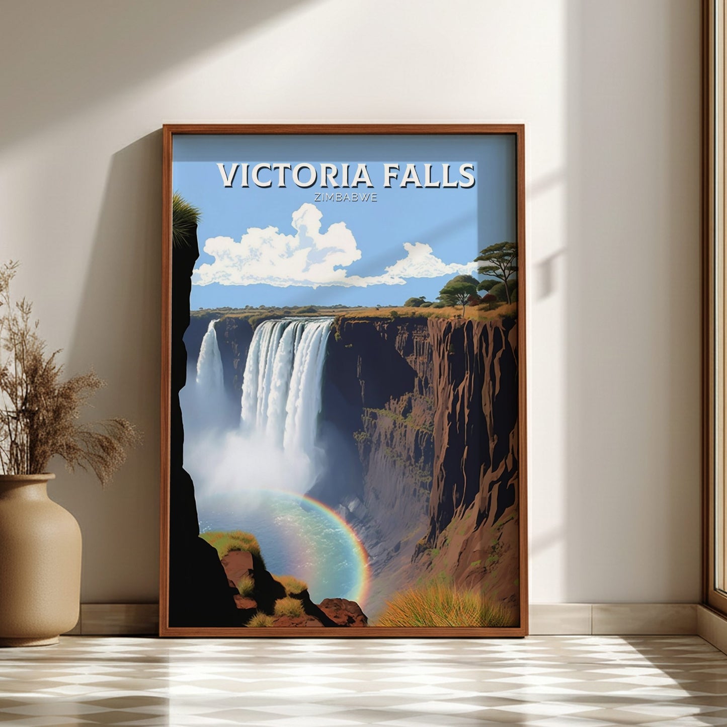 Framed poster of Victoria Falls with a rainbow, placed on a light wooden floor.