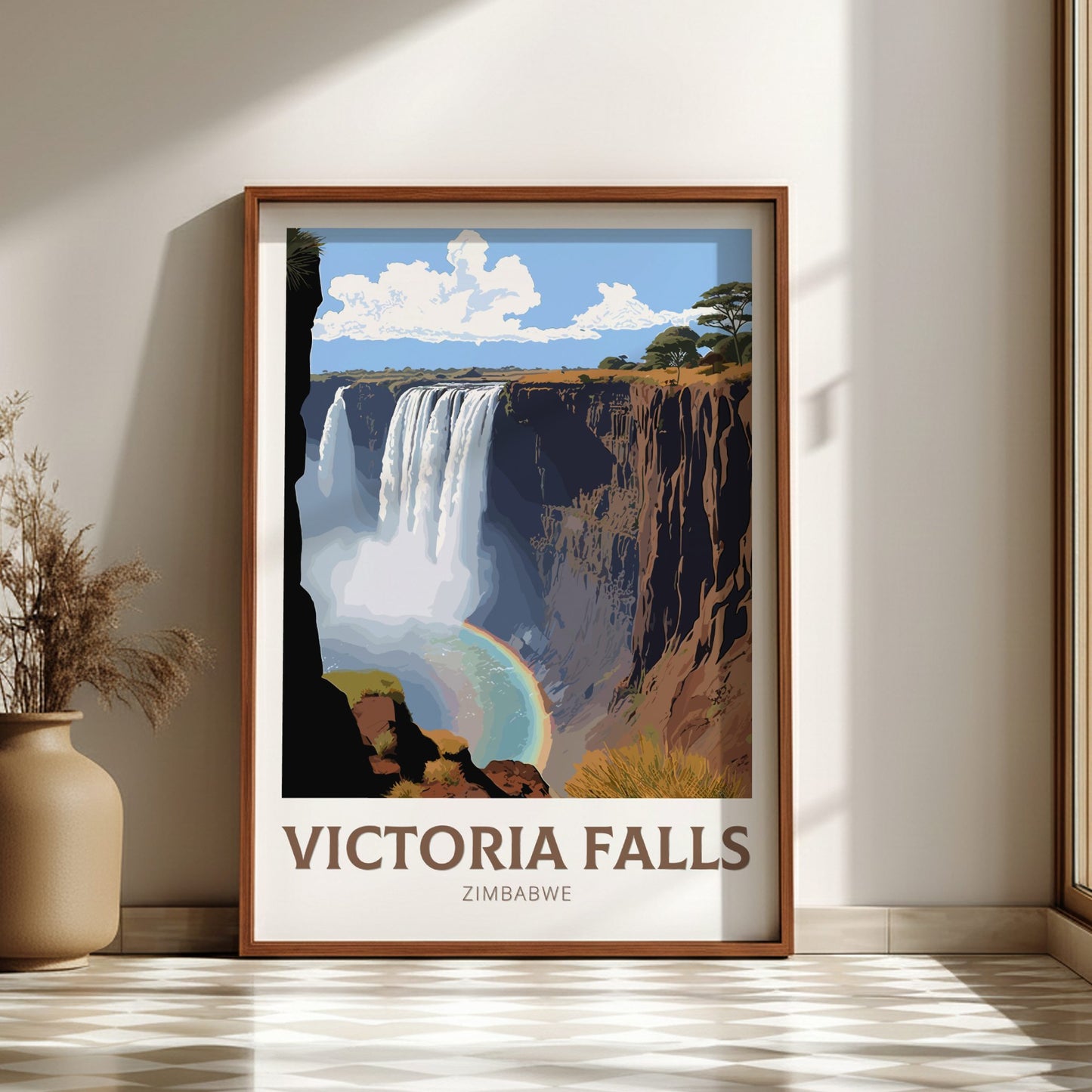 Framed poster of Victoria Falls on a wall with a vase and plant in the foreground.