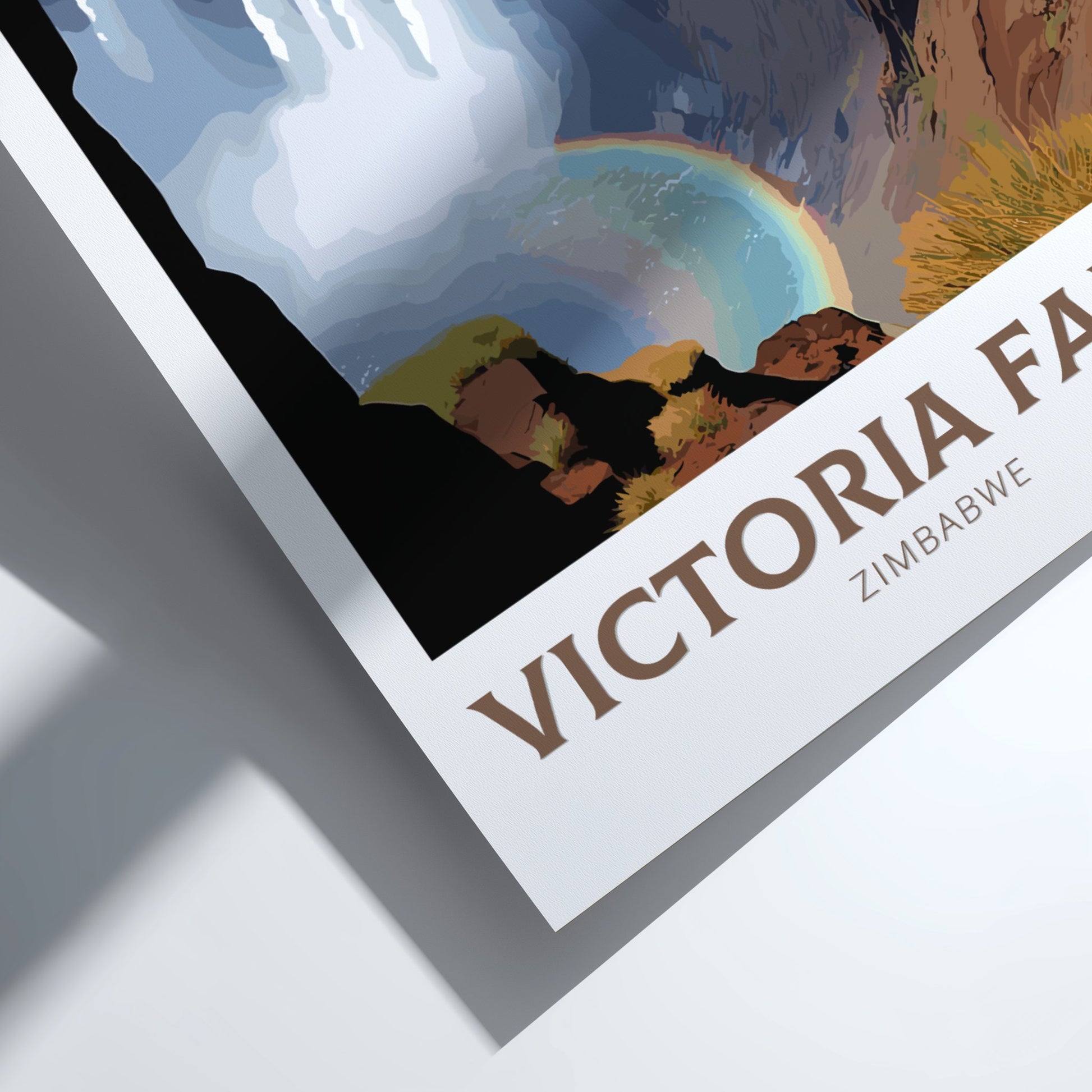Poster of Victoria Falls with a rainbow in the background on a white surface.