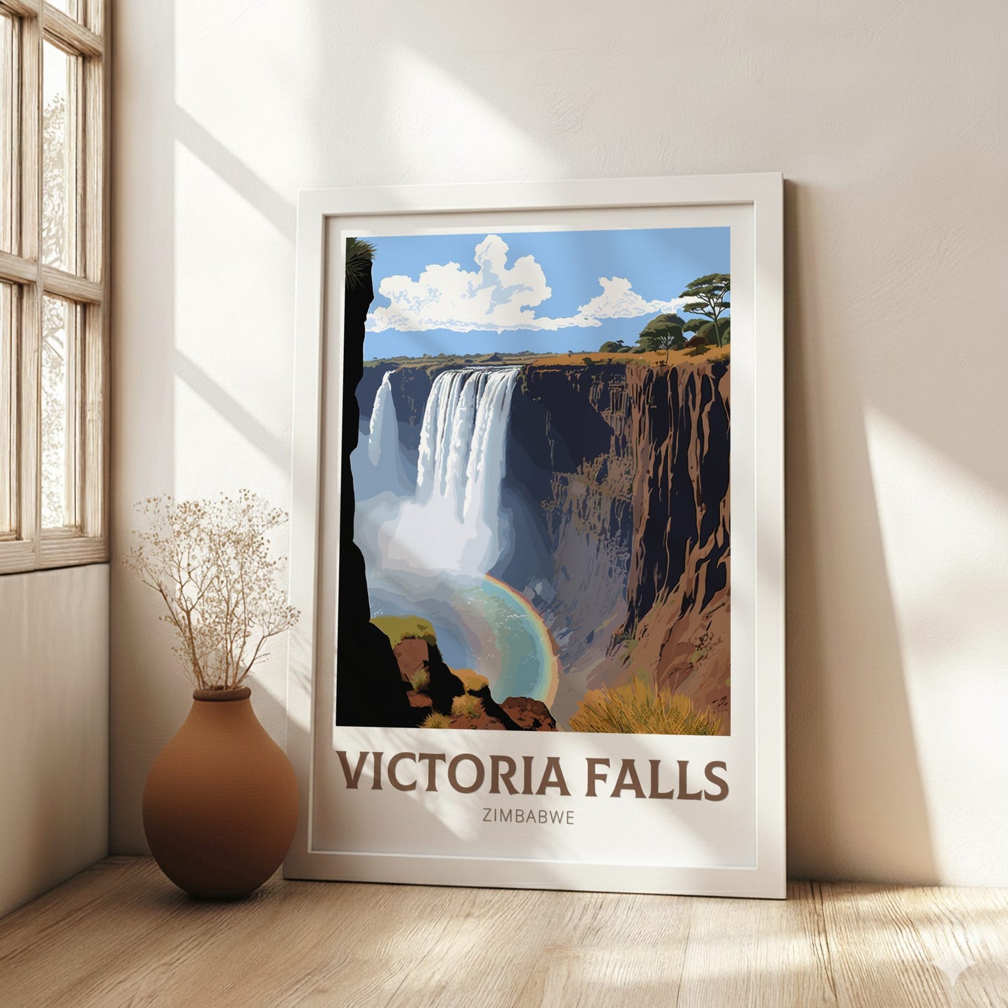 Framed poster of Victoria Falls in a room with a vase and window.