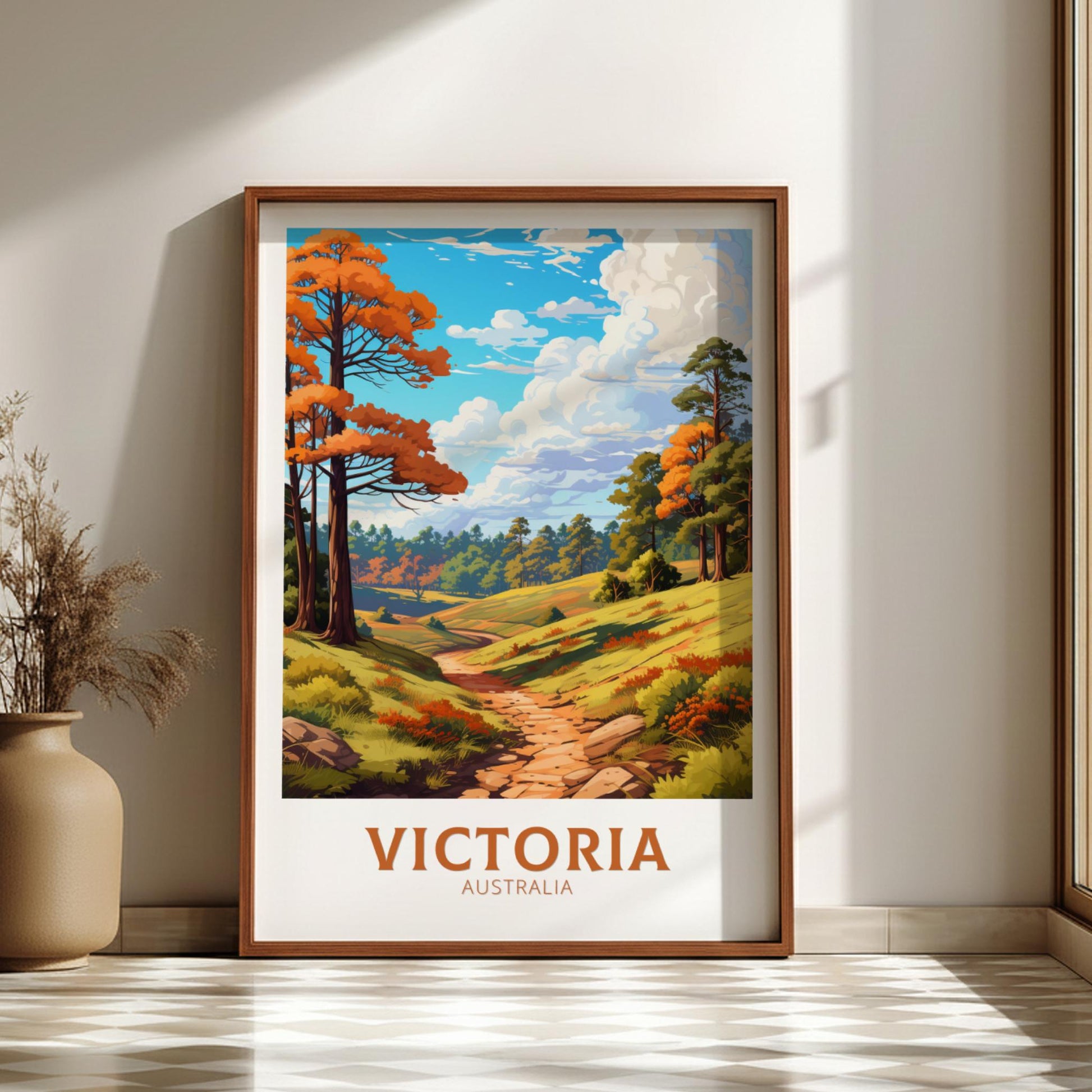 Framed artwork of a scenic landscape with trees and a path, labeled 'Victoria, Australia', on a wall.
