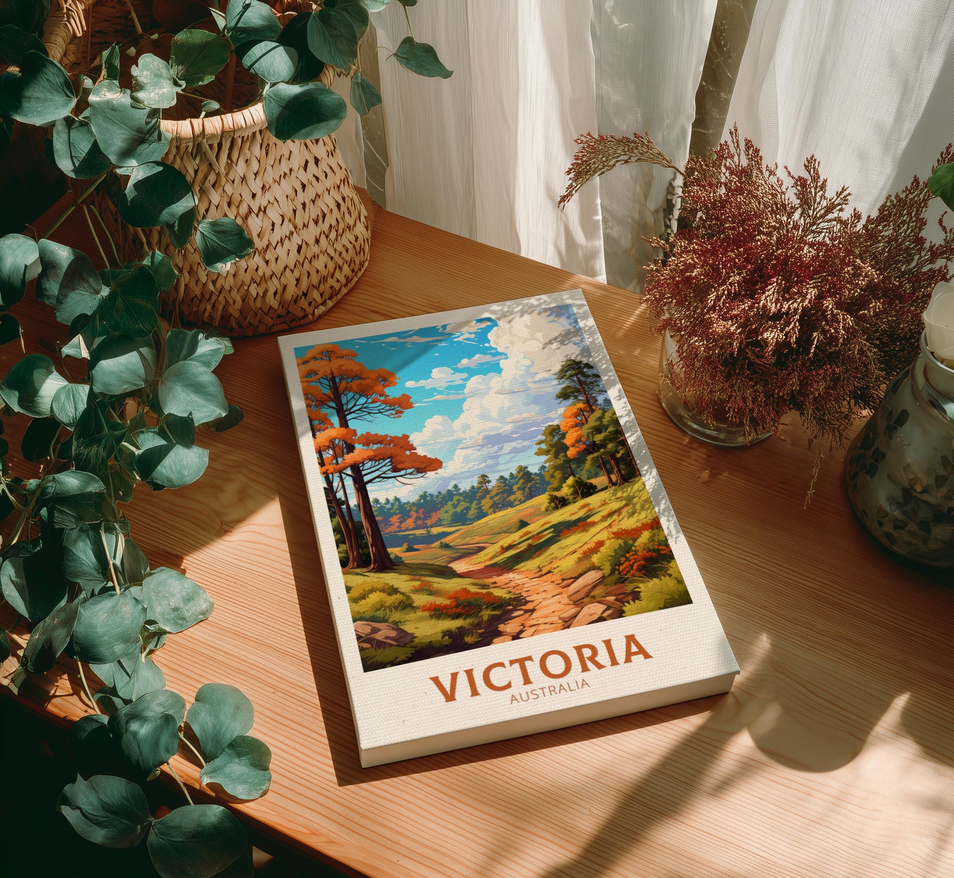 Canvas of 'Victoria Australia' on a wooden table with plants