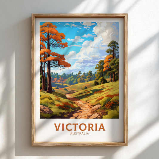 Framed artwork of a scenic landscape with trees and a path, labeled 'Victoria Australia' on a white wall.