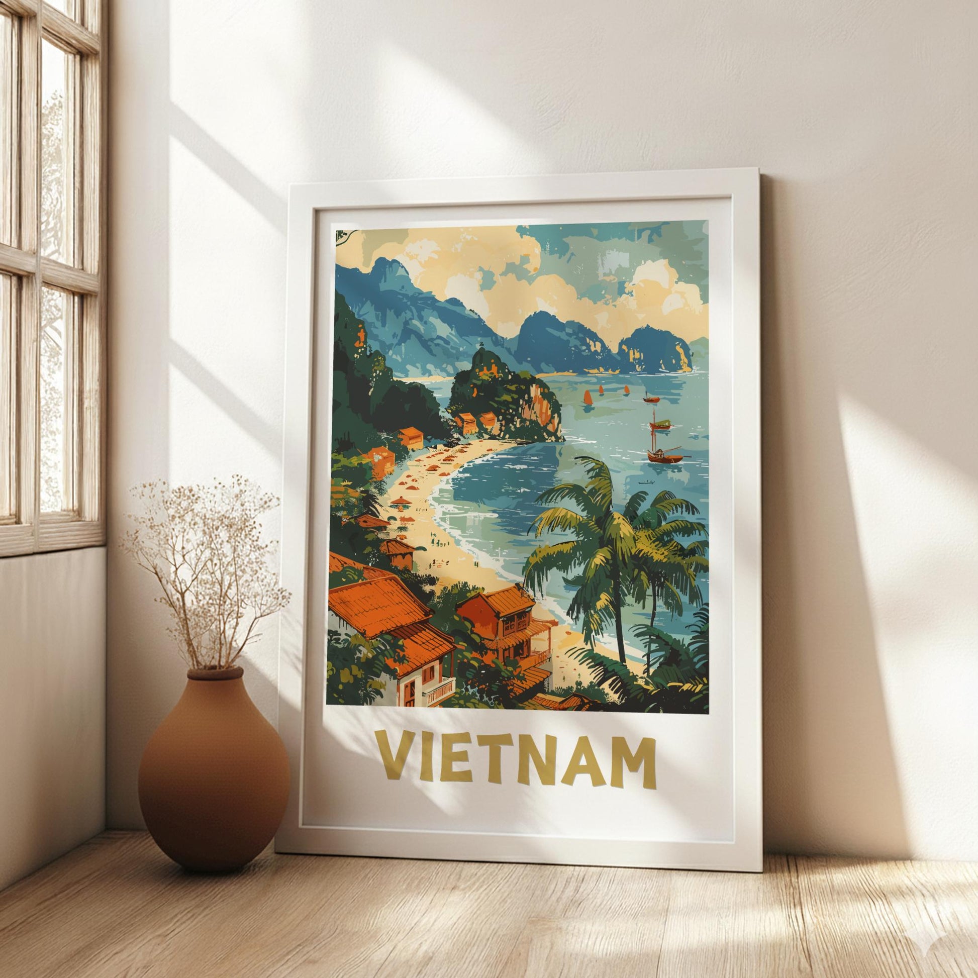 Framed poster of Vietnam with a scenic beach and mountains in a room with a vase.